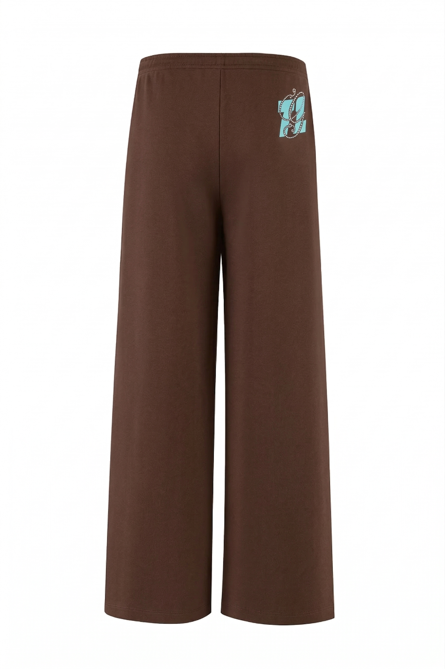The ARLO TRACK PANT by I.AM.GIA features brown French terry fabric, a wide-leg fit, and an elastic waistband with a light blue "g" logo near the back waist. A must-have for fans of baggy track pants. Shown on a white background.