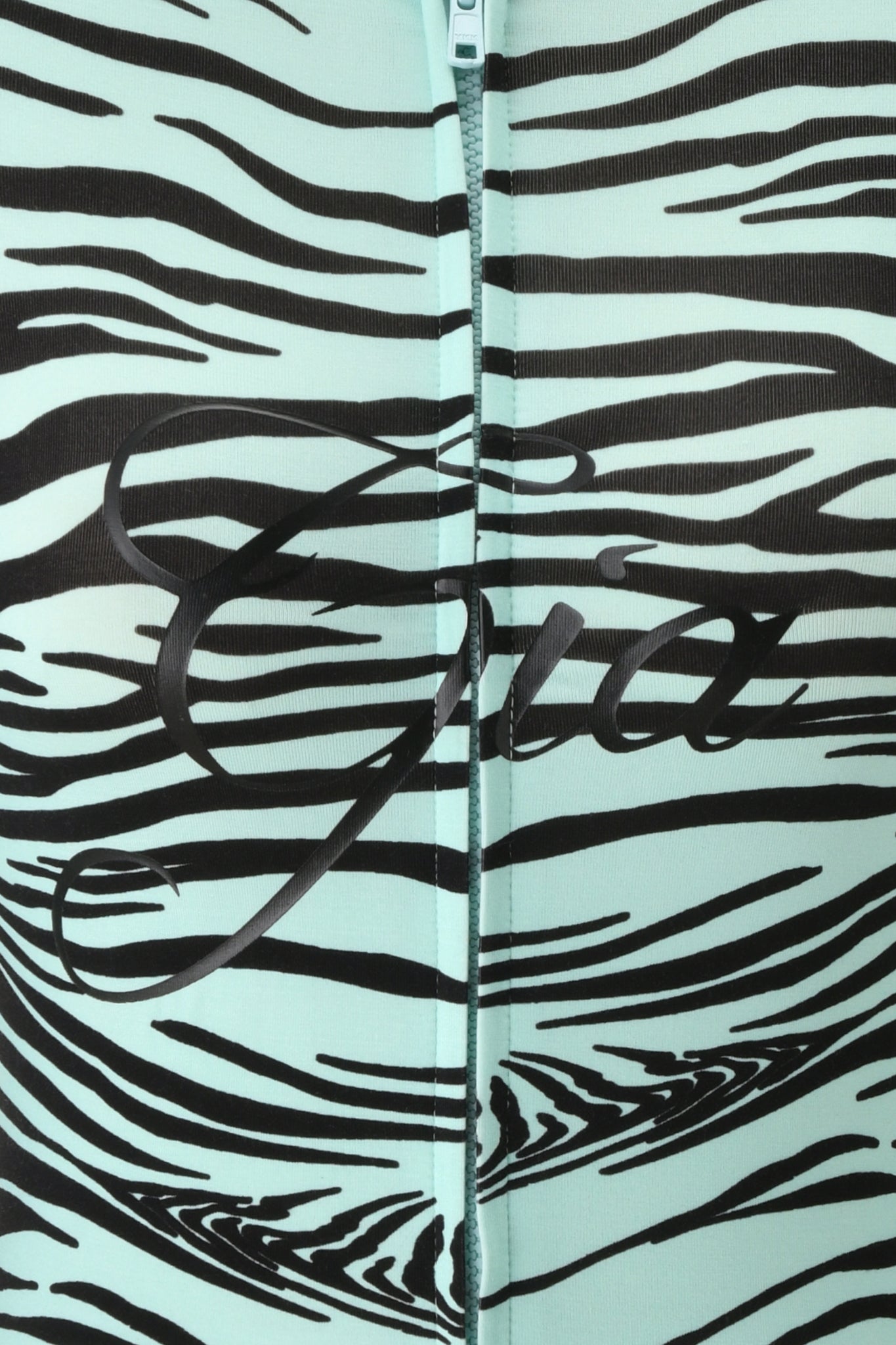 Close-up of the BLARE HOODIE - AQUA FINE LINE ZEBRA by I.AM.GIA, showcasing its mint green and black fine line zebra print with a central zipper. The name “Gia” appears in elegant black script across the middle, accentuating the hoodie’s distinctive style.
