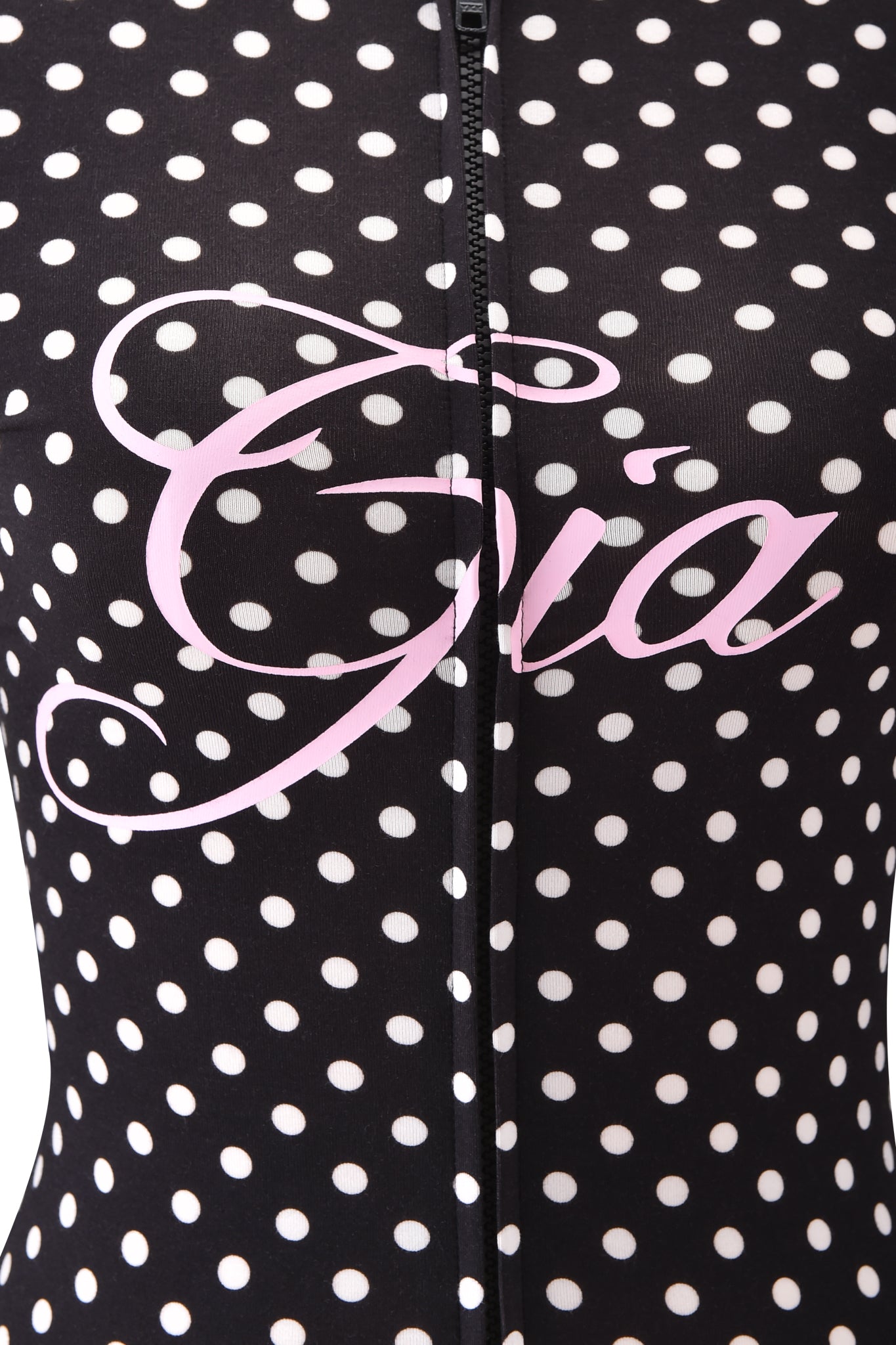 Close-up of the I.AM.GIA BLARE HOODIE - BLACK POLKA DOT, featuring a vertical zipper and "Gia" in bold, light pink cursive across the chest.