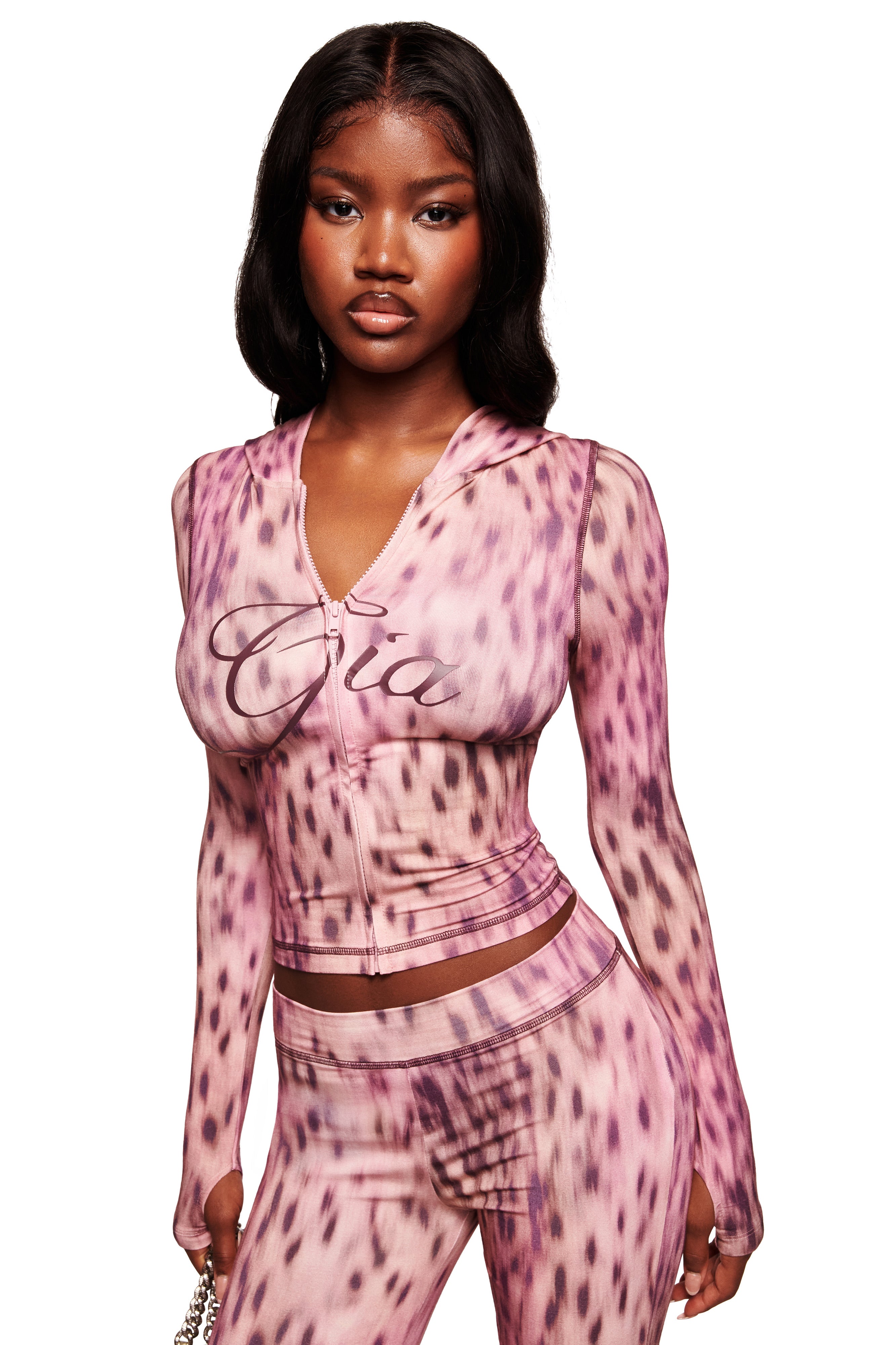 A woman wears the I.AM.GIA BLARE HOODIE in pink blurred cheetah print.