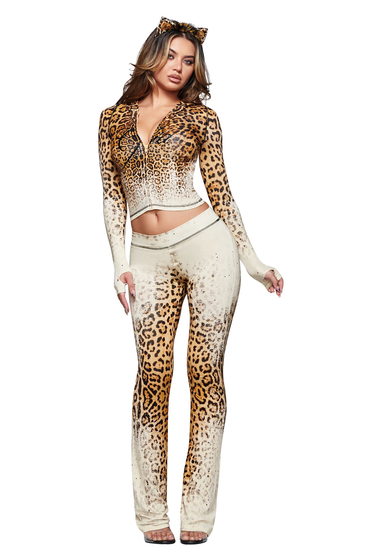 A woman is wearing the I.AM.GIA BLARE HOODIE in Cream Faded Panthera—crafted from soft bamboo fabrication and designed with a fitted silhouette, long sleeves, flared pants, and matching cat ears headband—standing against a white background.