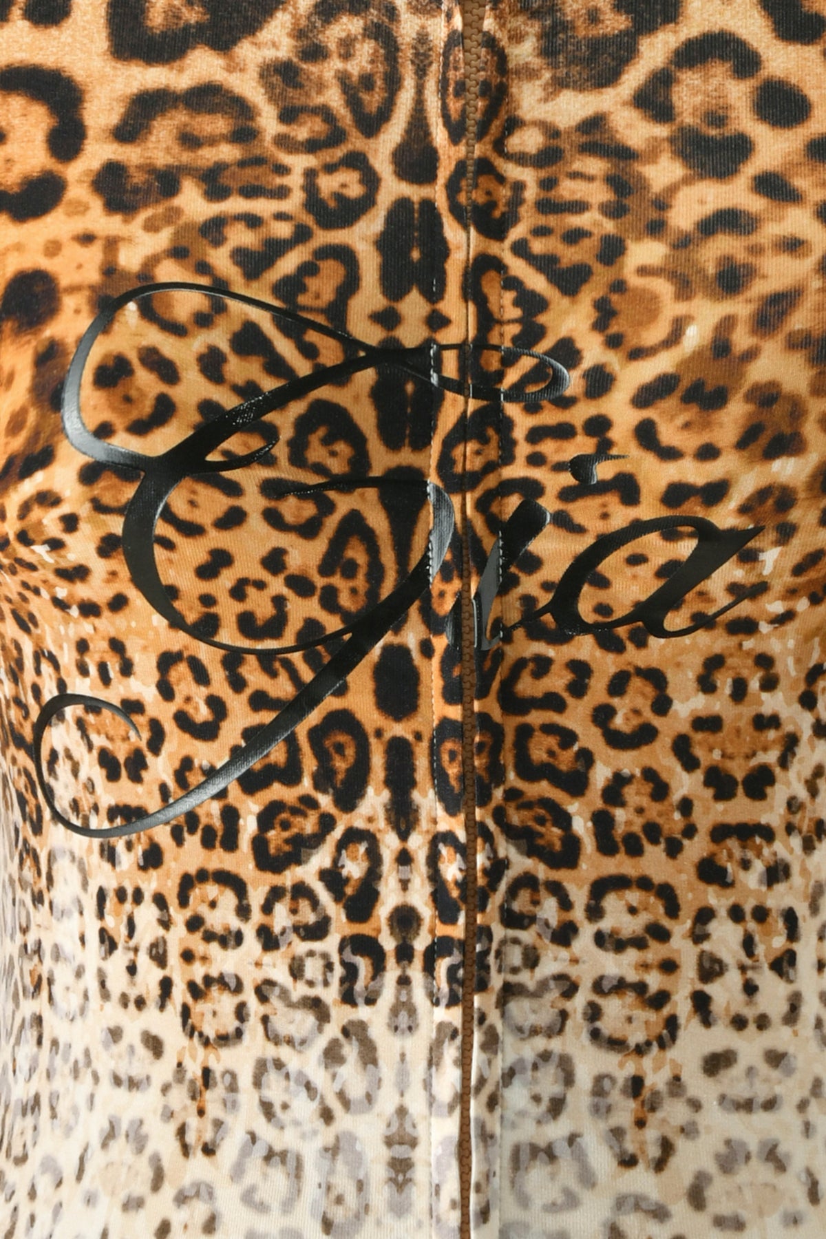 Close-up of fabric with a brown and black leopard print pattern, featuring black cursive writing across the center—perfect for the BLARE HOODIE - CREAM FADED PANTHERA by I.AM.GIA, crafted in soft bamboo fabrication to give a modern twist to the classic cheetah print hoodie style.