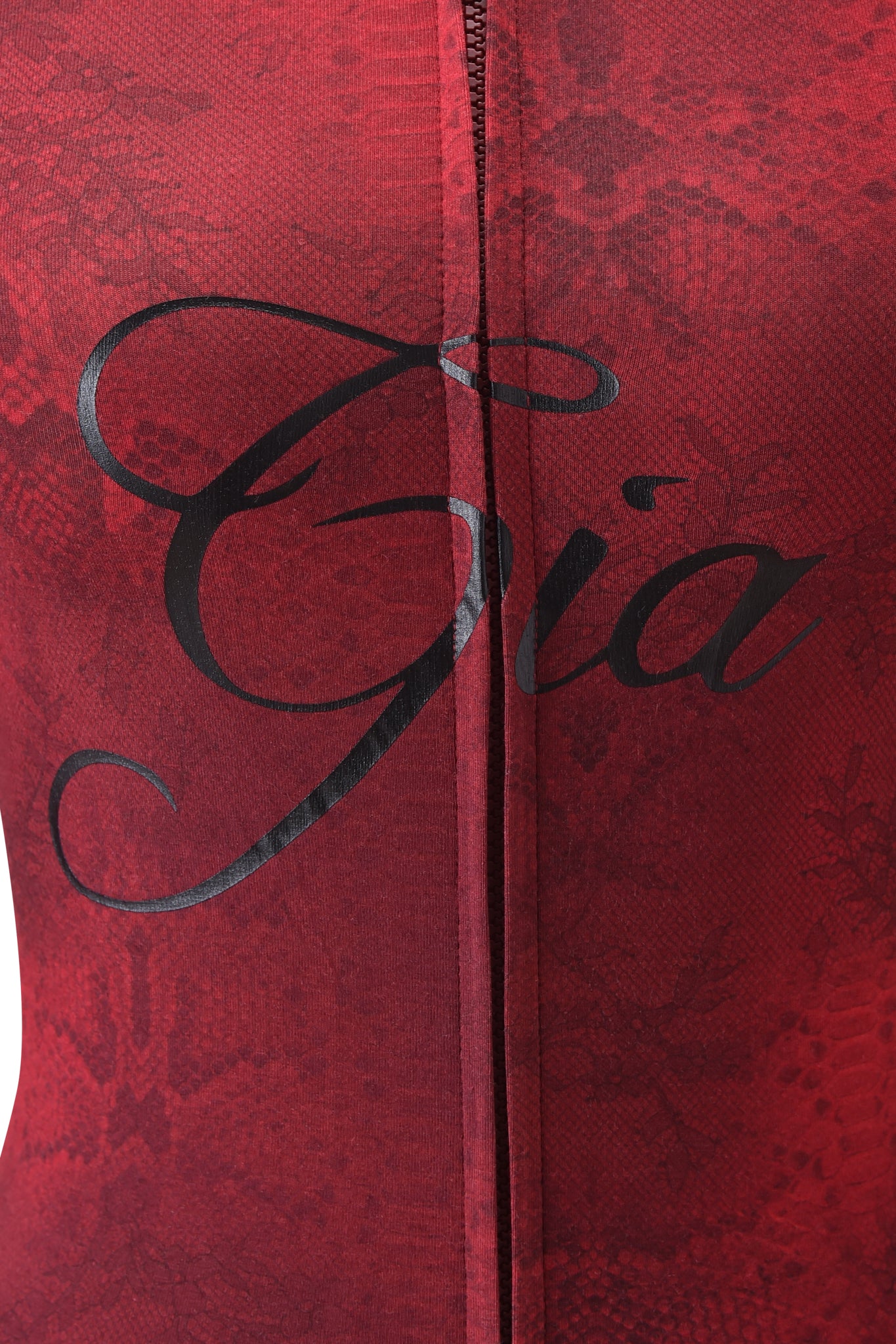 Close-up of the BLARE HOODIE - RED SERPENTINE by I.AM.GIA, showing red serpentine print fabric with a subtle snakeskin pattern and "Gia" in bold, black cursive across the center.