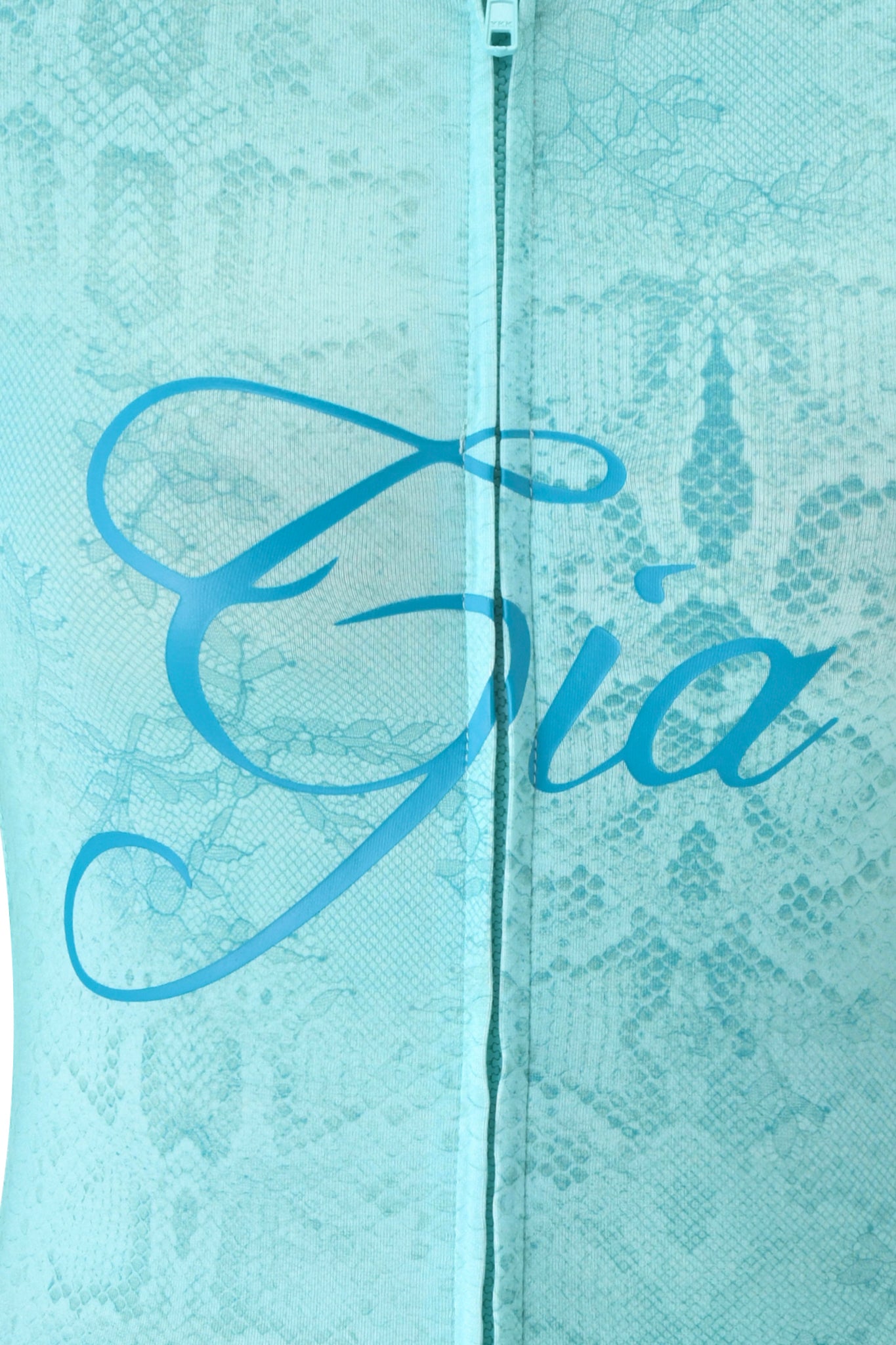 Close-up of light blue BLARE HOODIE - TEAL SERPENTINE by I.AM.GIA, featuring subtle lace, a teal snakeskin pattern, a central visible zipper, and "I.AM.GIA" elegantly displayed in large cursive across the middle.
