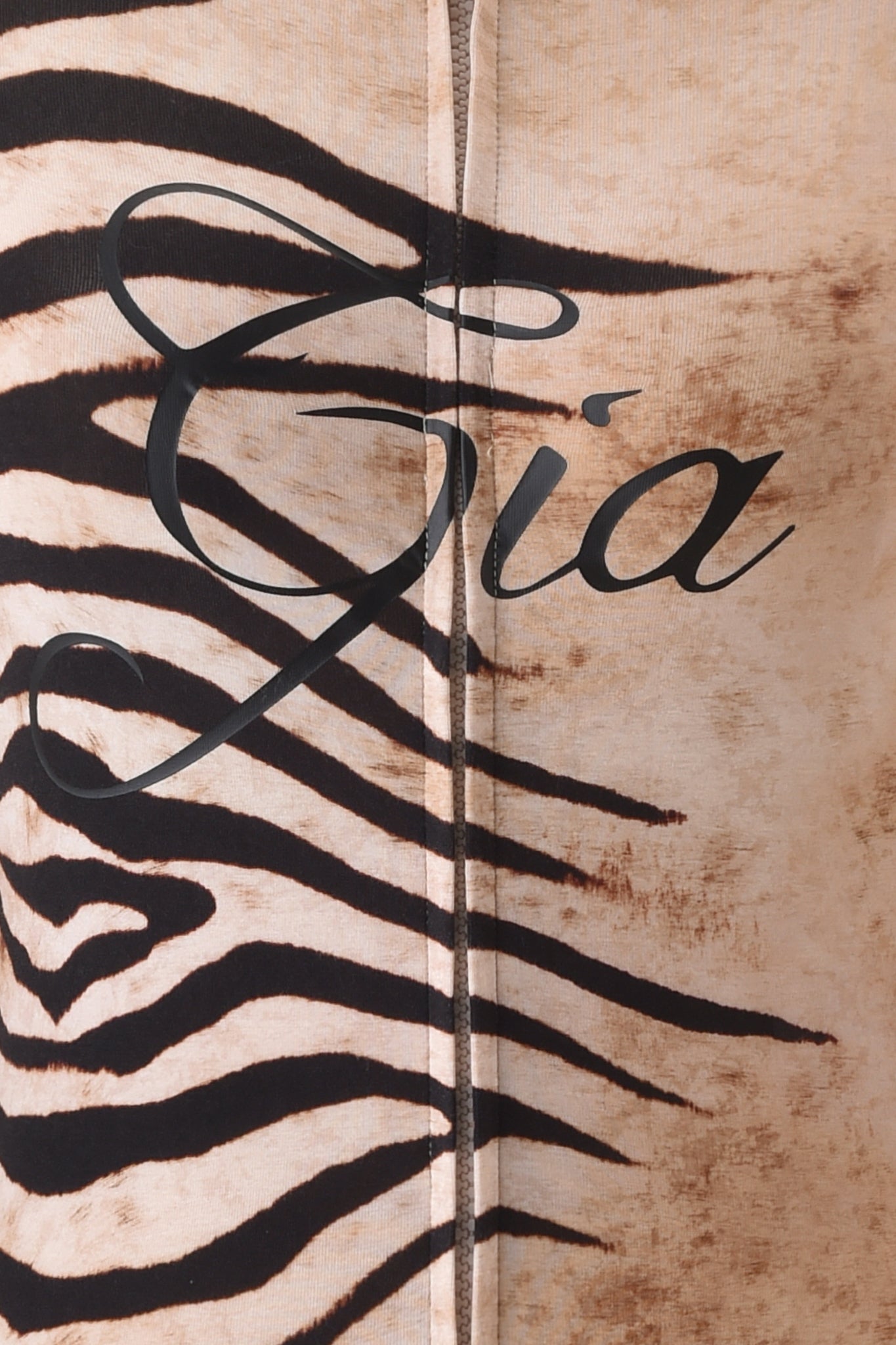 Close-up of the BLARE HOODIE - WILD SIDE by I.AM.GIA, featuring a beige and black wild side print with "Gia" in elegant script, crafted from soft bamboo fabric.