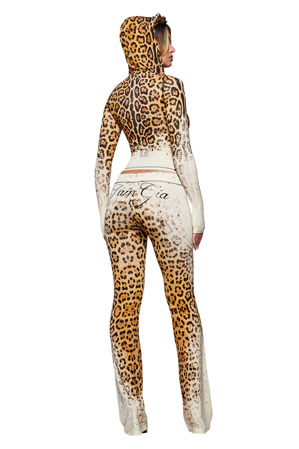 A person wearing the BLARE HOODIE - CREAM FADED PANTHERA by I.AM.GIA stands facing away, with “I.AM.GIA” displayed on the back. Made from comfortable bamboo fabrication, this fitted, full-body suit features realistic panthera spots and a gradient that fades to cream at the legs and sleeves.