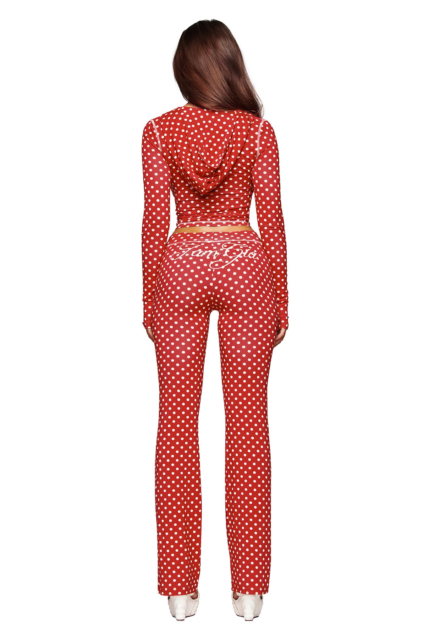 A woman with long brown hair faces away, wearing the I.AM.GIA BLARE HOODIE in red polka dot, posed against a white background.
