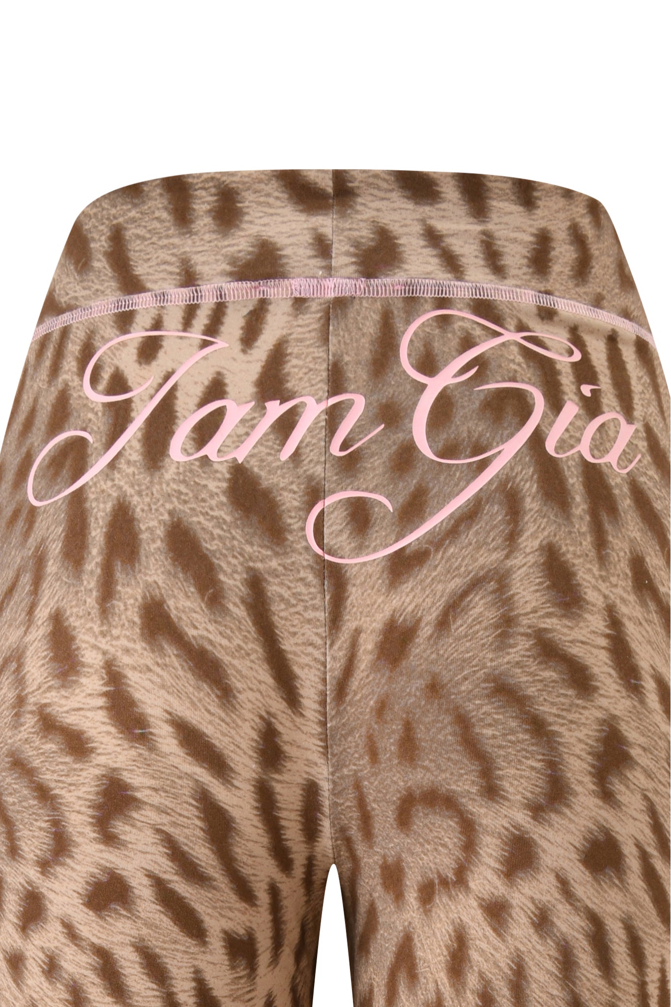 Close-up of blaze cheetah print fabric with pink cursive "I.AM.GIA" text across the top, evoking the signature bold look of the BLARE TRACKPANT by I.AM.GIA.