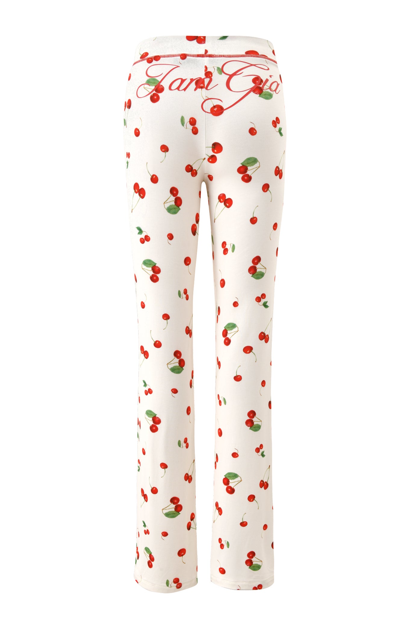 The BLARE TRACKPANT - CHERRY ON TOP by I.AM.GIA features white bamboo pajama pants with a playful cherry print and "Ganni Girl" in red cursive on the waistband, offering ultimate comfort and charm. Shown from the back.