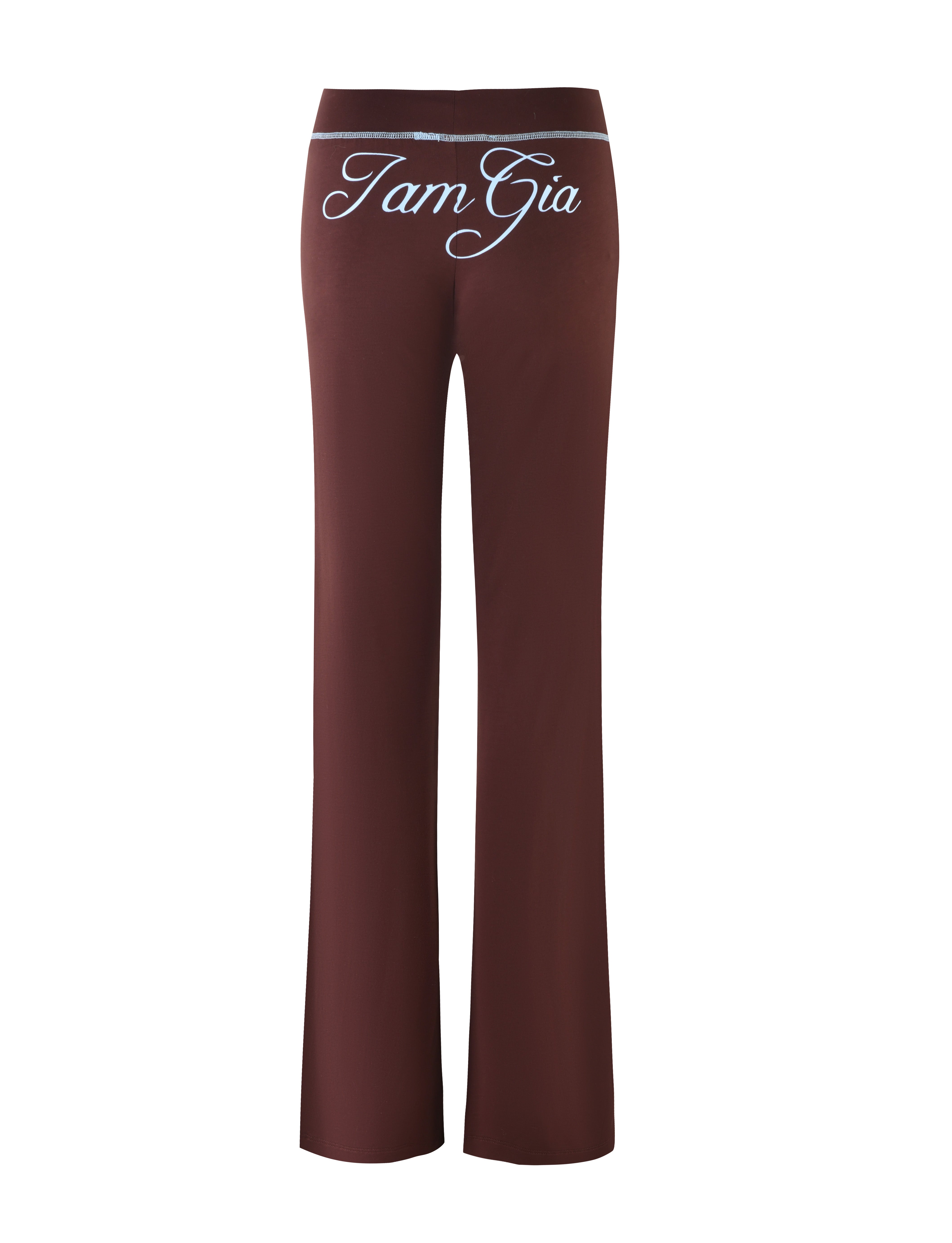 A pair of long, chocolate brown Blare Trackpants from I.AM.GIA with "Tam Gia" written in white cursive font on the back. These relaxed fit trackpants seem to be made of soft, stretchy bamboo fabric.