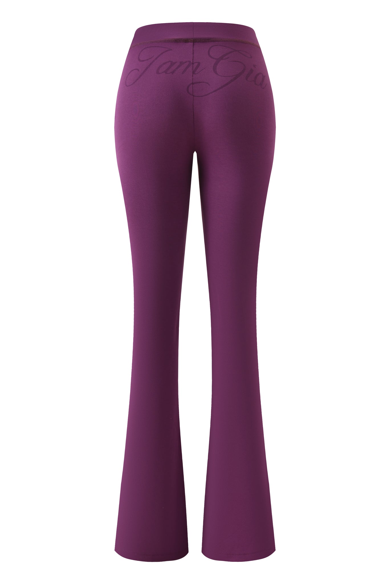 The I.AM.GIA BLARE TRACKPANT - PLUM is shown from the back, highlighting its high-waisted fit and cursive text printed across the waistband.