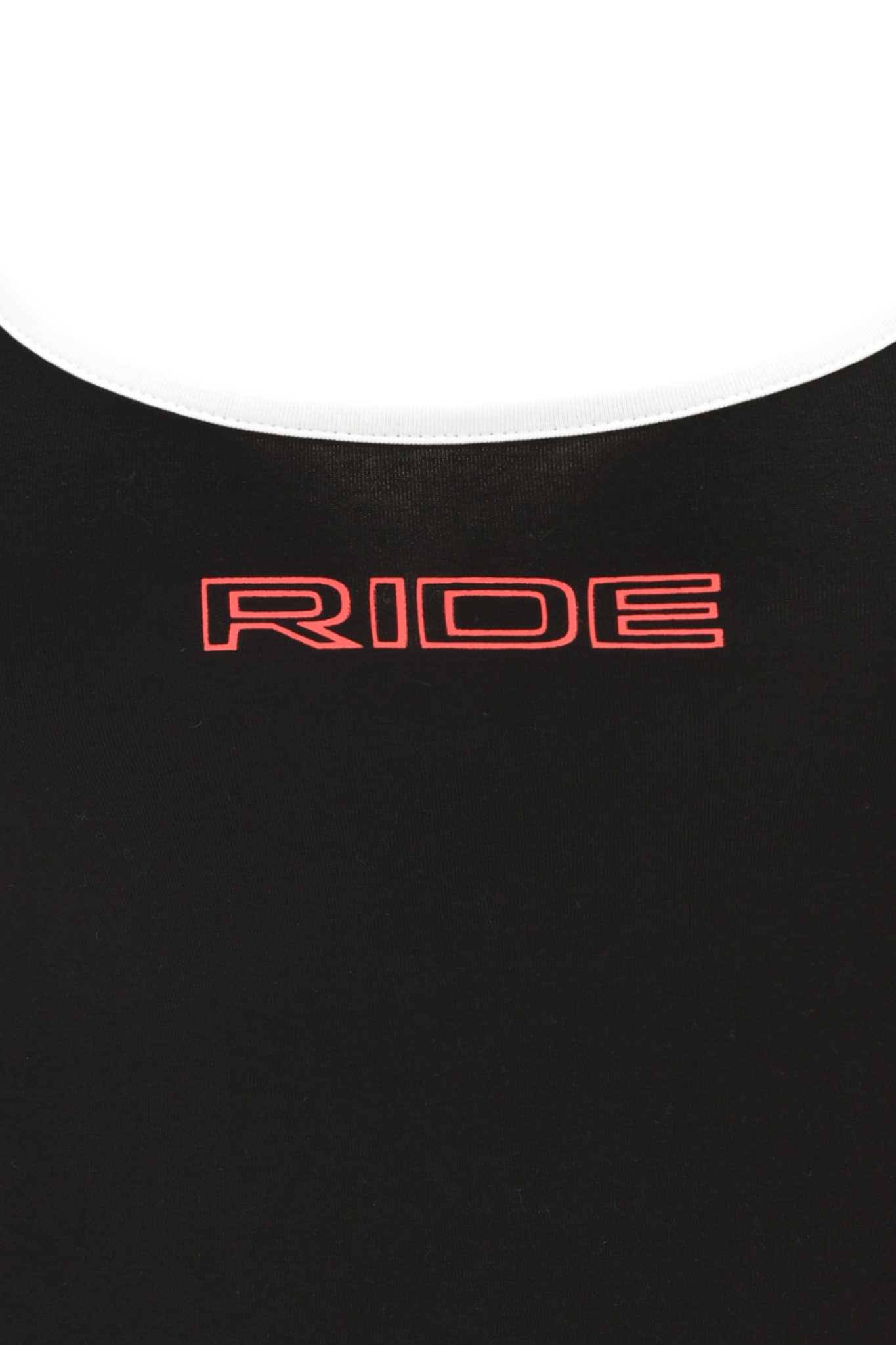 Close-up of black fabric from the SHAYLA TANK - BLACK by I.AM.GIA, showcasing bold red 'RIDE' artwork in uppercase with a thin white border—featuring the brand’s signature graphic detail.