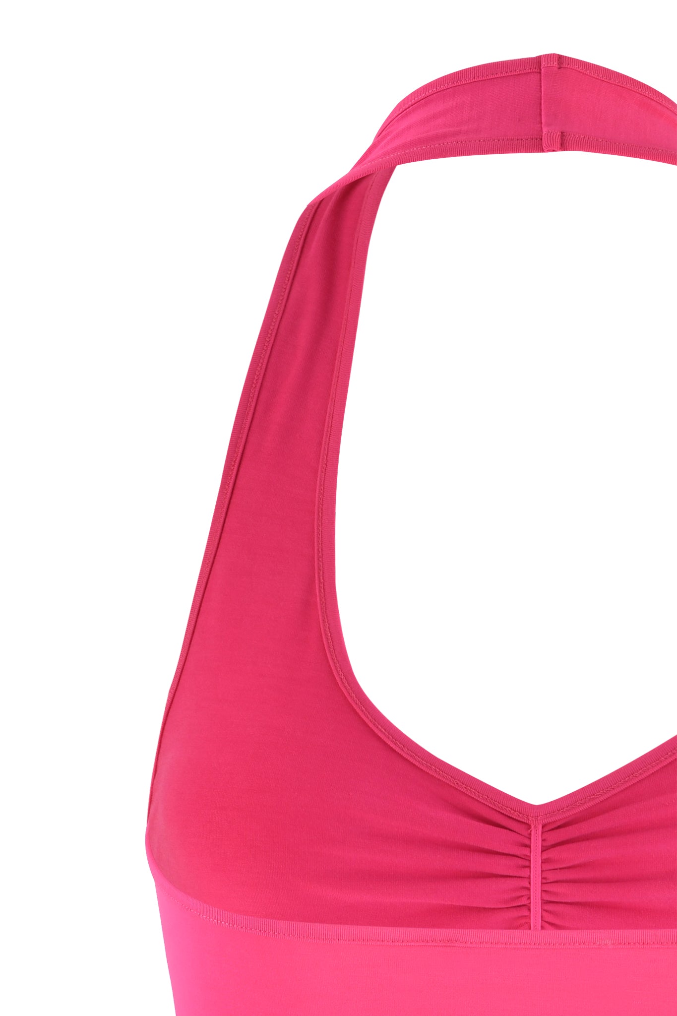 Close-up of a vibrant hot pink CELESTE TOP by I.AM.GIA. The sleeveless halter-style top features fabric that gathers slightly below the neckline, creating a subtle ruched effect. The strap loops around the neck, leaving the shoulders bare. The image captures the upper portion of the garment, showcasing its texture and design.