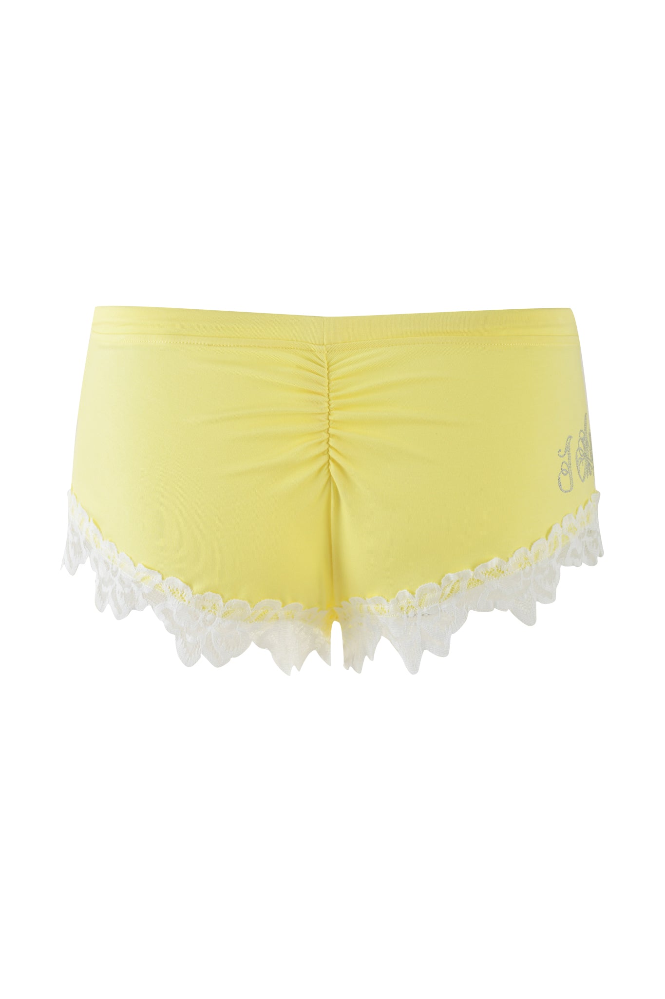 The CELESTE SHORT in Baby Yellow by I.AM.GIA showcases a bodycon silhouette with white lace trim at the hem. The design features gathered fabric at the back for a ruched effect and includes a subtle floral pattern on the side.