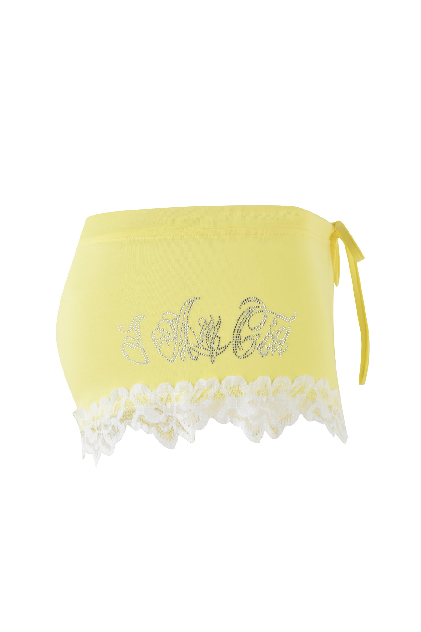 A baby yellow CELESTE SHORT by I.AM.GIA, adorned with white lace trim at the bottom and rhinestone embellishments spelling "A Juicy Girl" in cursive, features a custom logo print. Its micro mini length and side drawstring detail enhance its flirty bodycon silhouette.