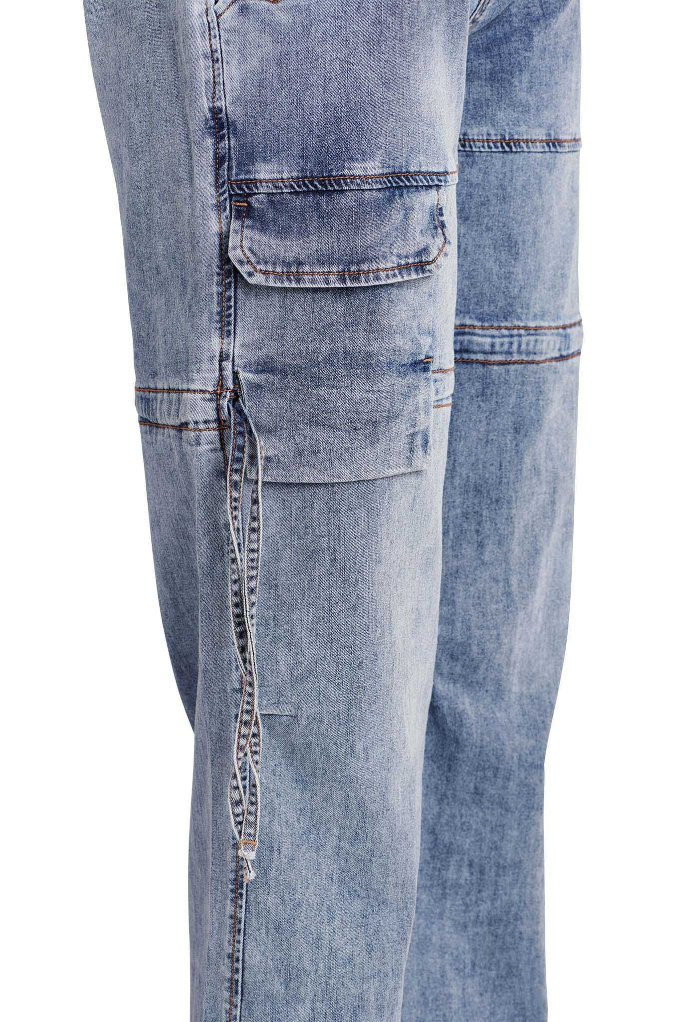 Close-up view of the I.AM.GIA NAIMA CARGO PANT - DENIM, showcasing a cargo pocket detail on the side. The jeans feature a faded wash with visible stitching and a casual, slightly worn look.