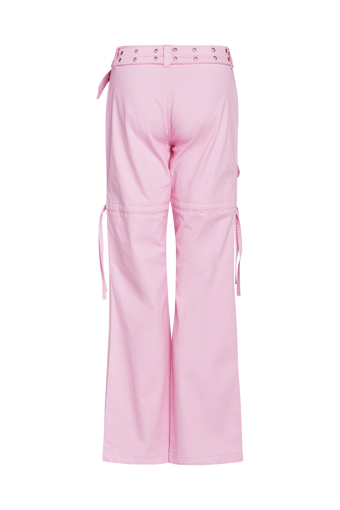 The NAIMA CARGO PANT - PINK BABY from I.AM.GIA is shown from the back, displaying its loose fit and high waist. The pants feature a fabric belt with eyelets, side pockets, and additional fabric straps on the sides. The leg hems are slightly flared for added style.