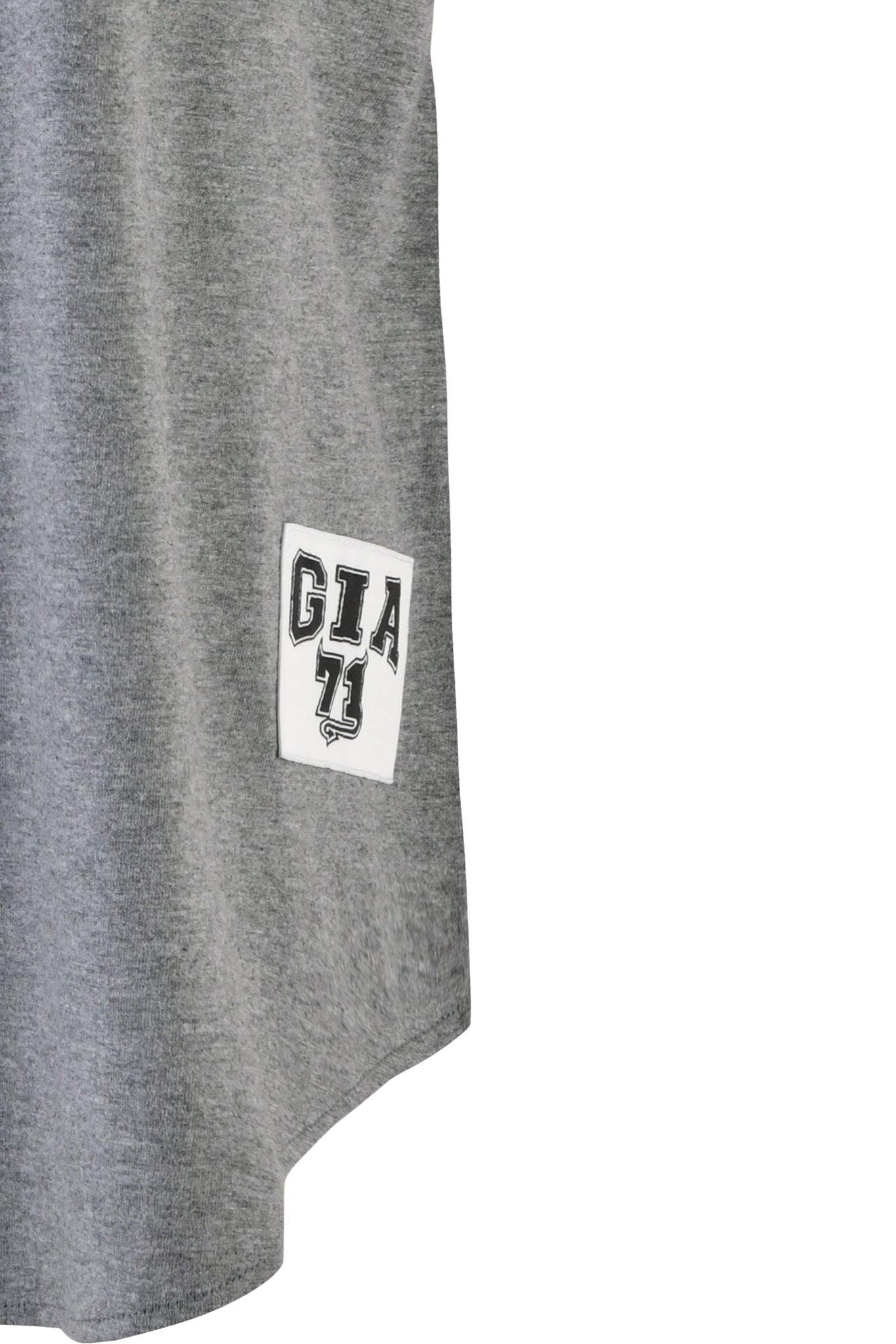 Image of a section of the LORRI JERSEY in steel grey from I.AM.GIA, showcasing a small white patch near the bottom left corner. The patch displays bold black letters "GIA" and the number "71" in a sporty font, characteristic of I.AM.GIA's signature style.
