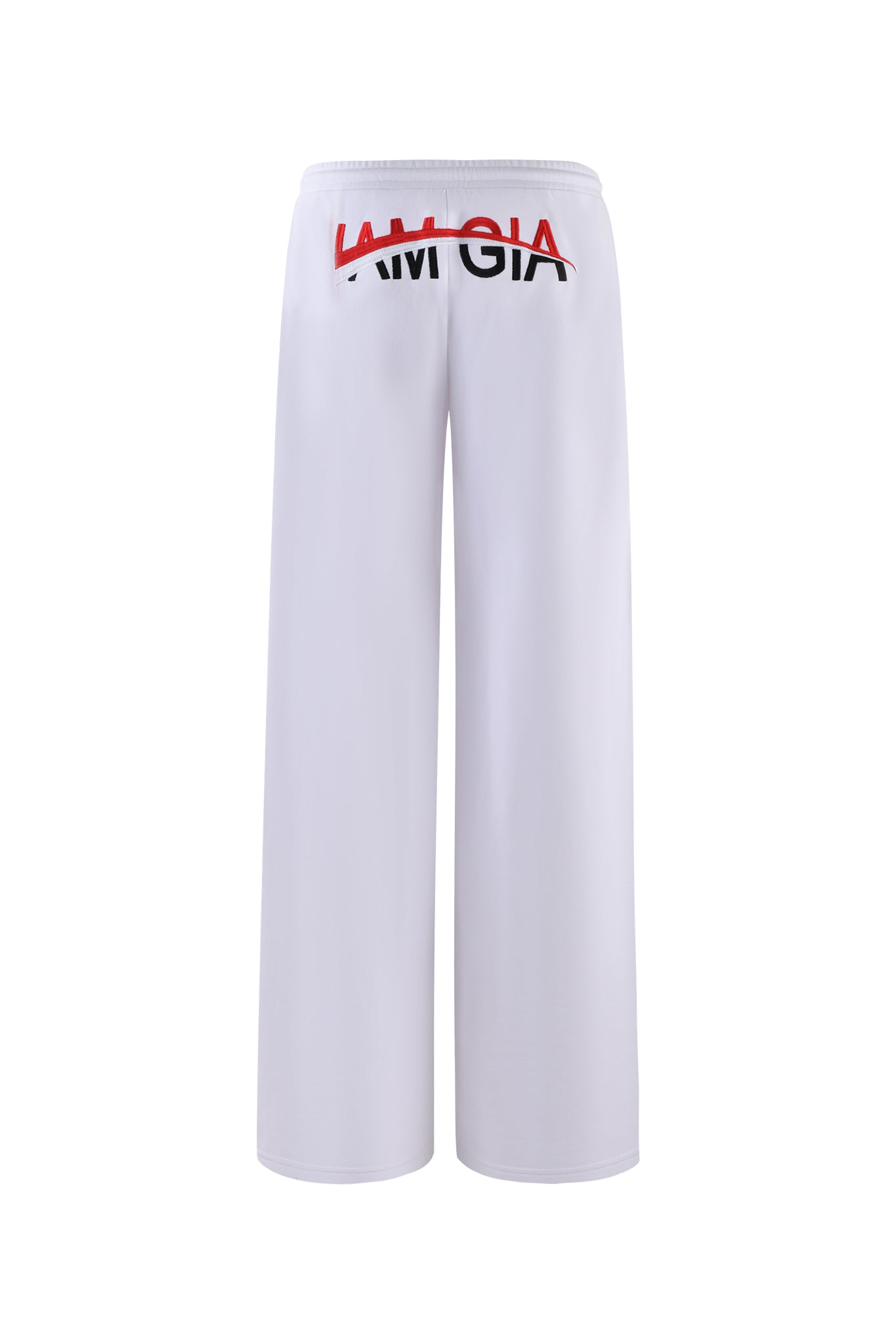 The JUSTINE PANT - WHITE from I.AM.GIA are white wide-leg pants featuring an elastic waistband. The back of the pants is adorned with the text "I AM GIA" in black and red, with a red line partially obscuring the word "AM". The pants are shown on a plain white background.