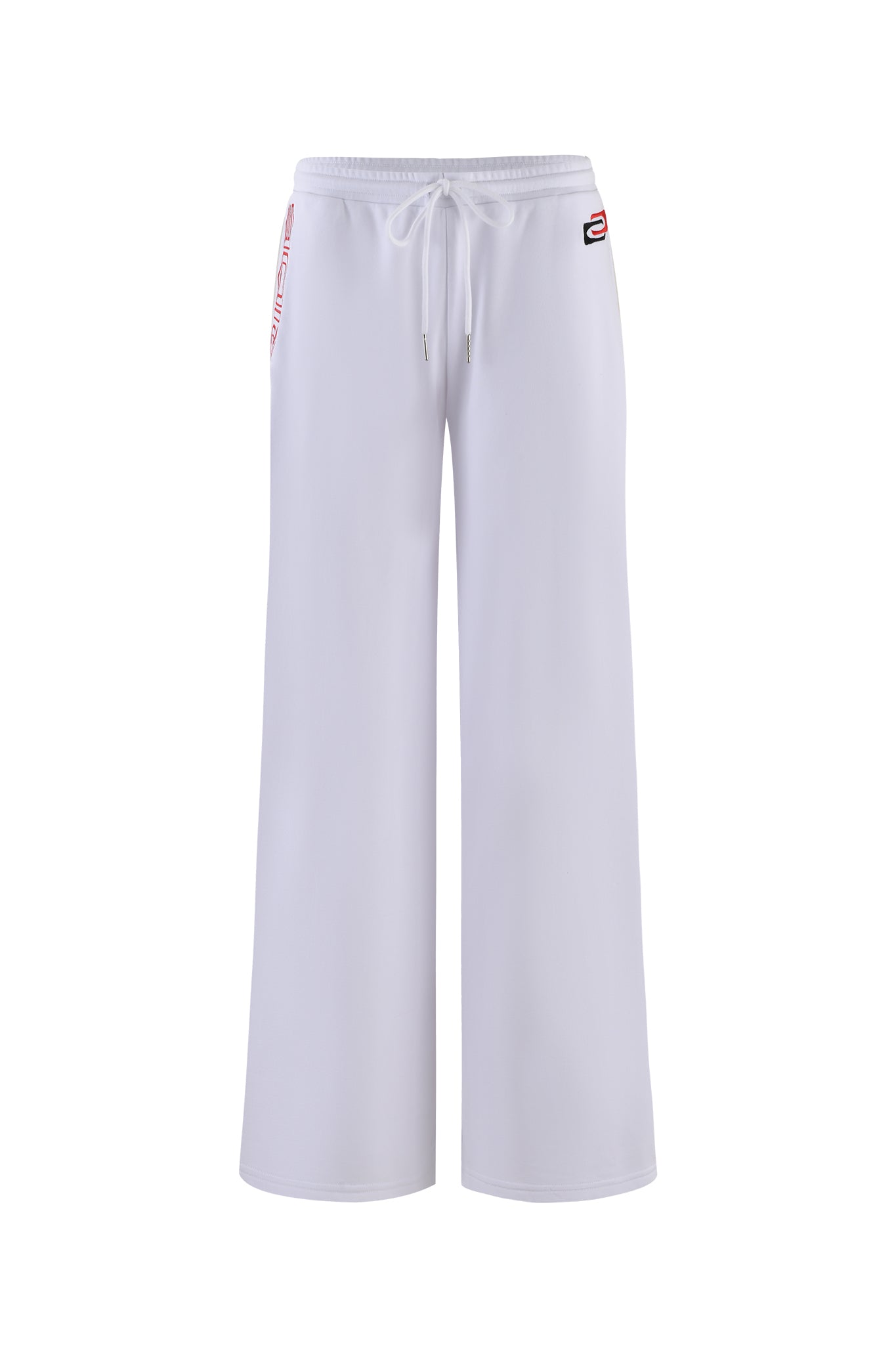 The JUSTINE PANT - WHITE by I.AM.GIA is a pair of white, wide-legged pants featuring an elastic waistband with a drawstring. A small red and black I.AM.GIA logo adorns the right pocket area, with no other visible markings or patterns. The pants are photographed against a plain white background.