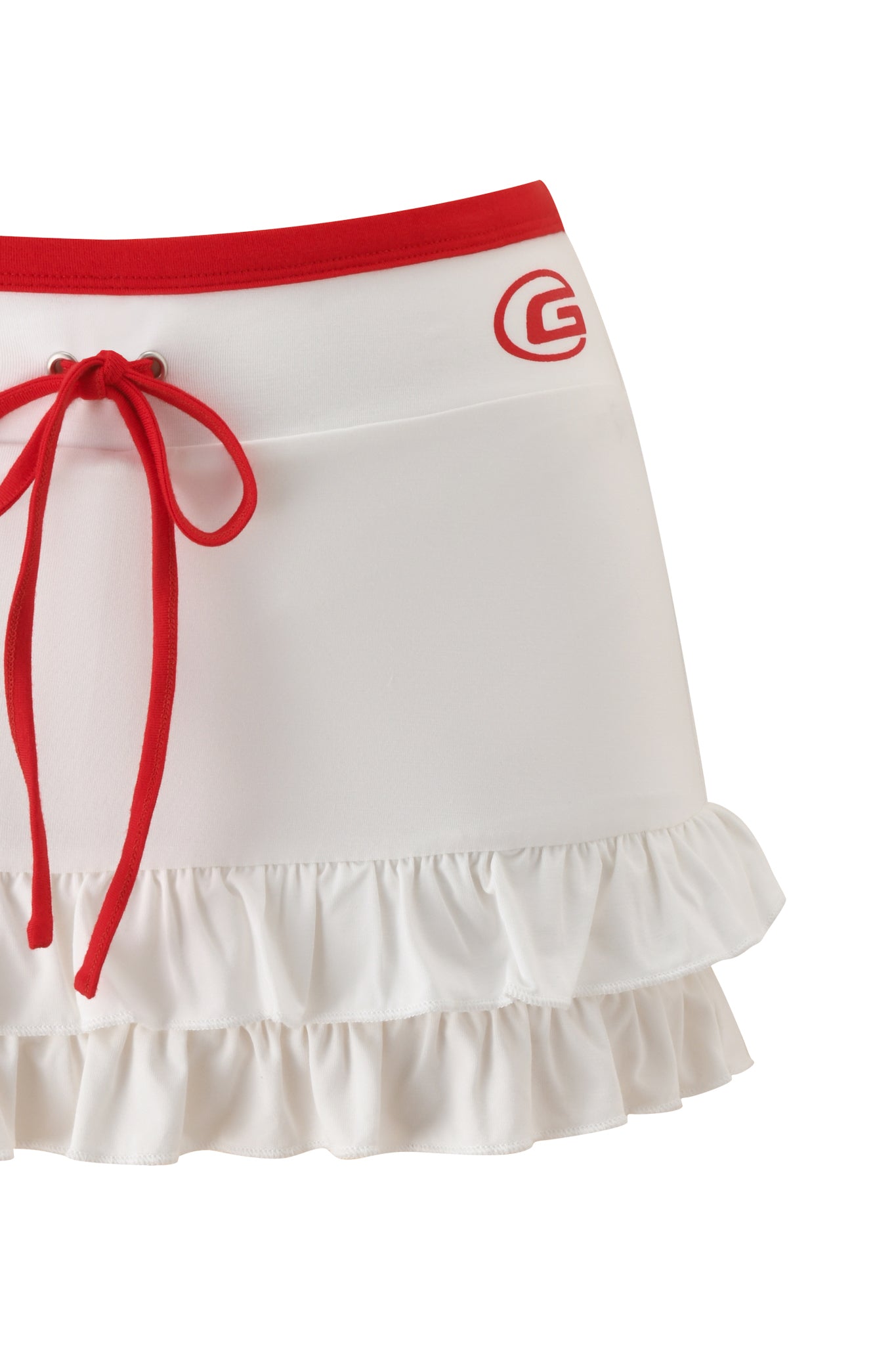 The MICHELLE SKORT - WHITE by I.AM.GIA is a white micro mini skort with a red waistband, drawstring tie, low-rise fit, ruffled hem, and features a red "G" logo near the waist.