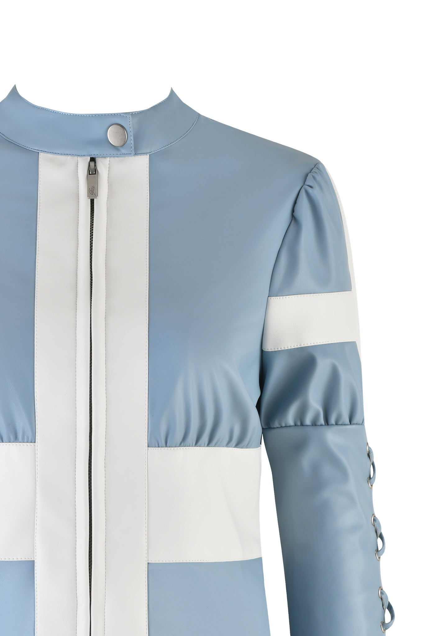 Here's a revised sentence using the provided product data:
Close-up of the I.AM.GIA Lambretta Jacket in baby blue and white faux leather, featuring a high collar with a snap button at the neck. This jacket showcases a vertical white stripe down the center, puff shoulders, fixed lace-up detailing on the sides, and button details along the side of the sleeves.