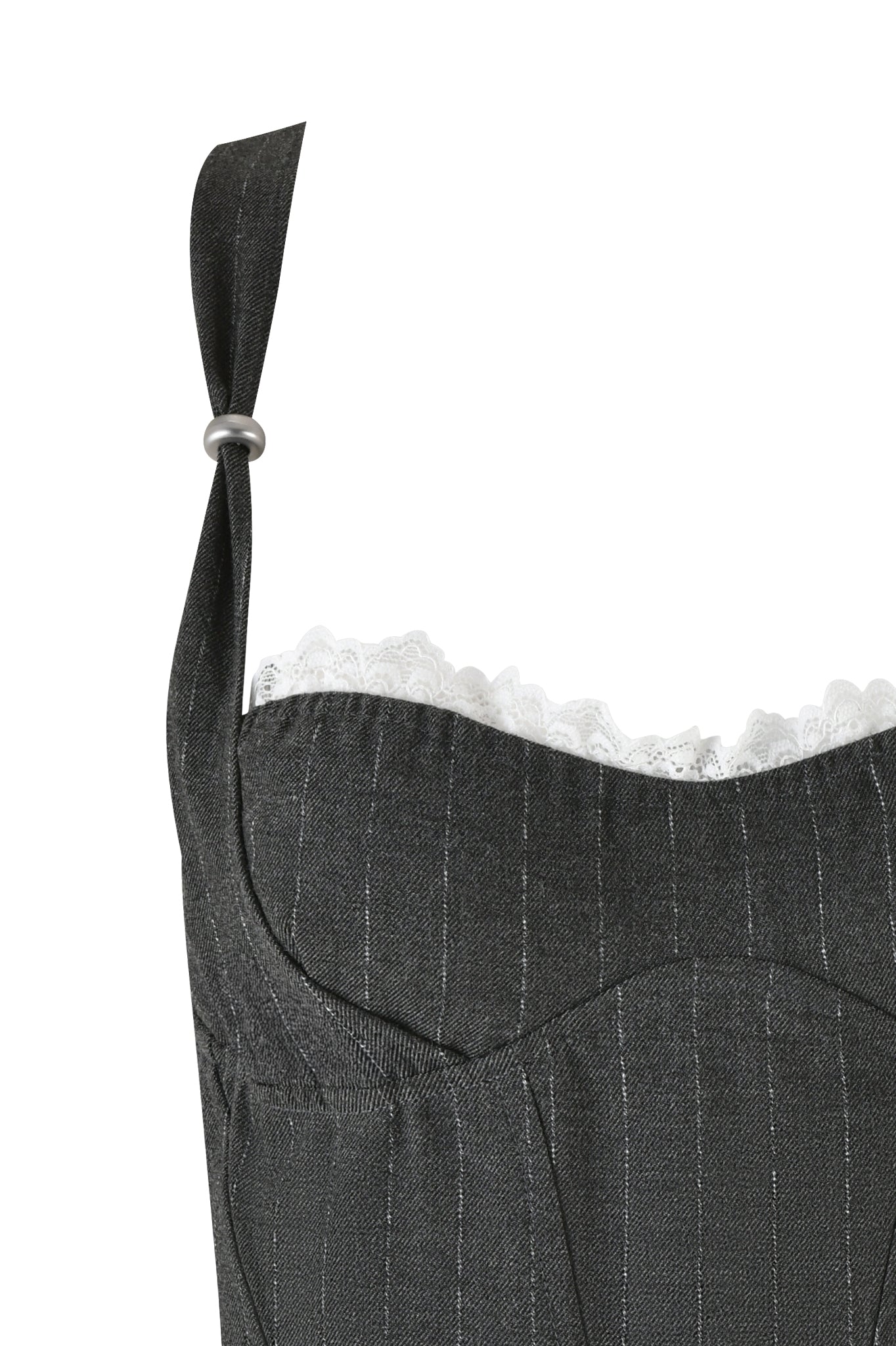 Close-up of the MARRION CORSET - GREY: PINSTRIPE dress by I.AM.GIA, featuring a single shoulder strap with a silver buckle. The dress boasts a scalloped sweetheart neckline adorned with white lace trimming peeking out at the top. The fabric appears textured, highlighting its tailored fit and intricate design details.