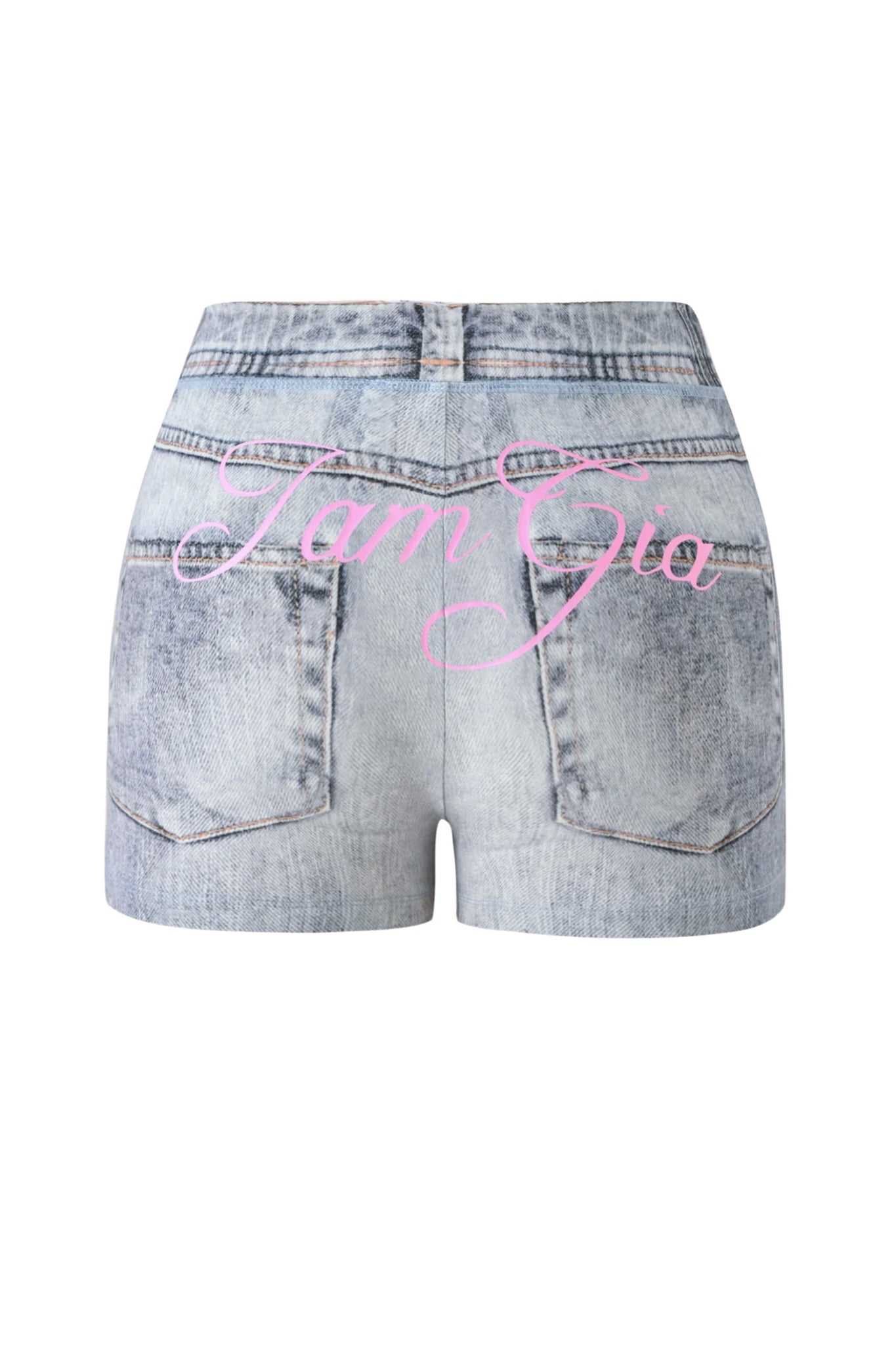 The BLARE SHORT - DENIM TROMPE L’OEIL by I.AM.GIA is featured from the back, showcasing a light-wash denim print with “Tam Gia” in pink cursive text across the pockets and waistband.