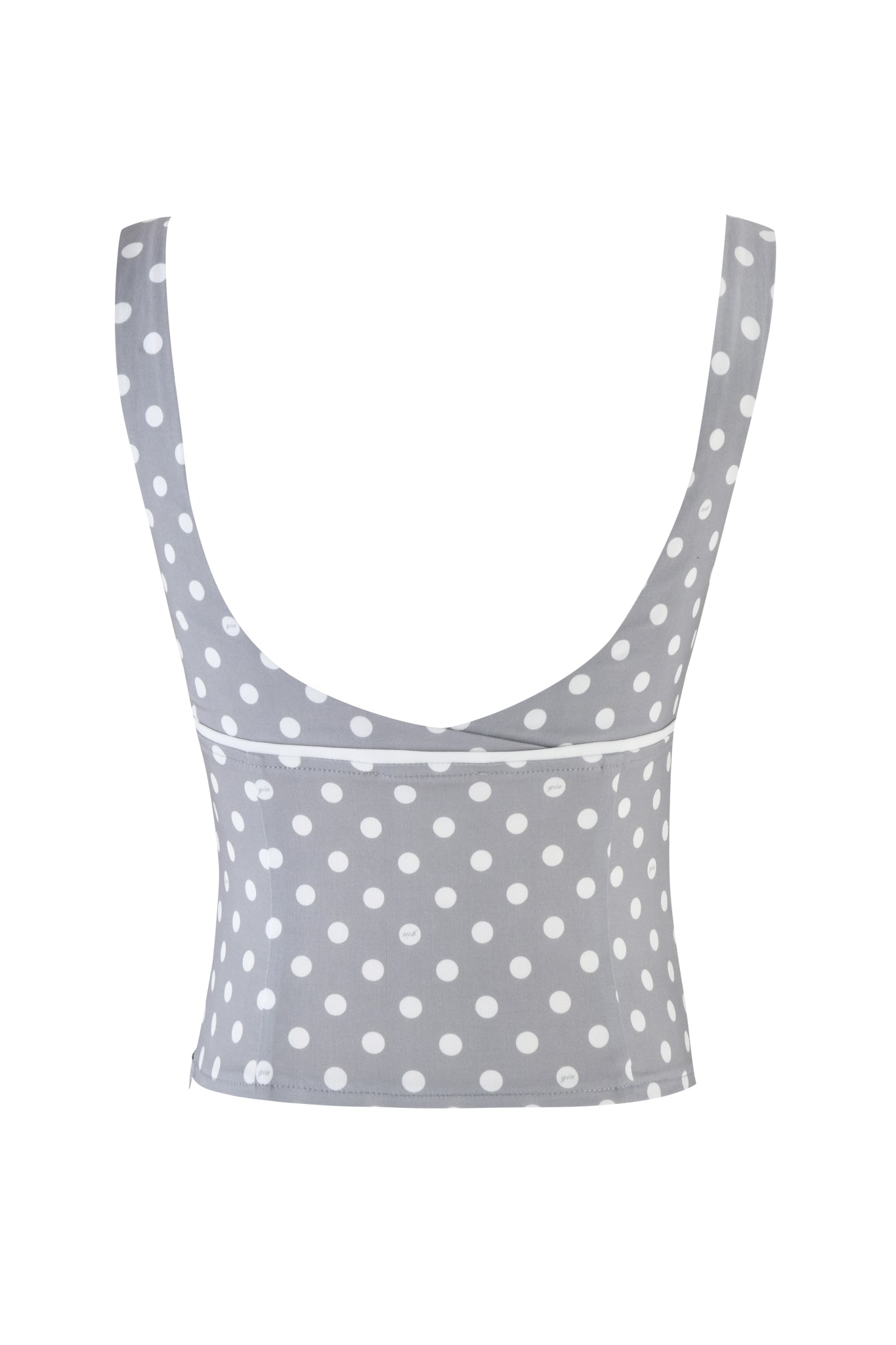 The MELDA TOP by I.AM.GIA is a gray polka dot crop top with white lace detailing, wide shoulder straps, and a scoop neckline. It features an invisible side seam zipper and is presented on a crisp white background.