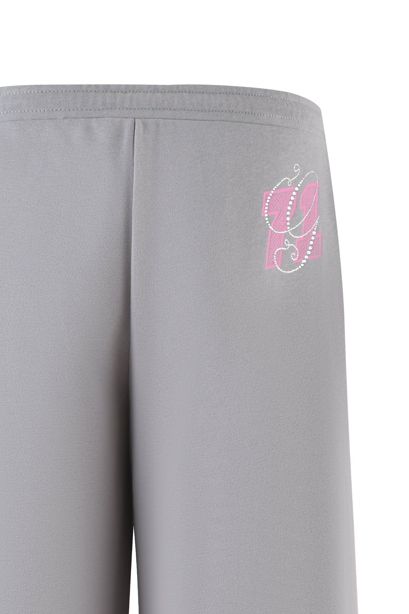 Close-up of ARLO TRACK PANT - GREY : PINK by I.AM.GIA, showing wide leg track pants with a decorative pink and white design including the number 99 in stylized font on the upper left. Features smooth fabric and an elastic waistband for comfort.
