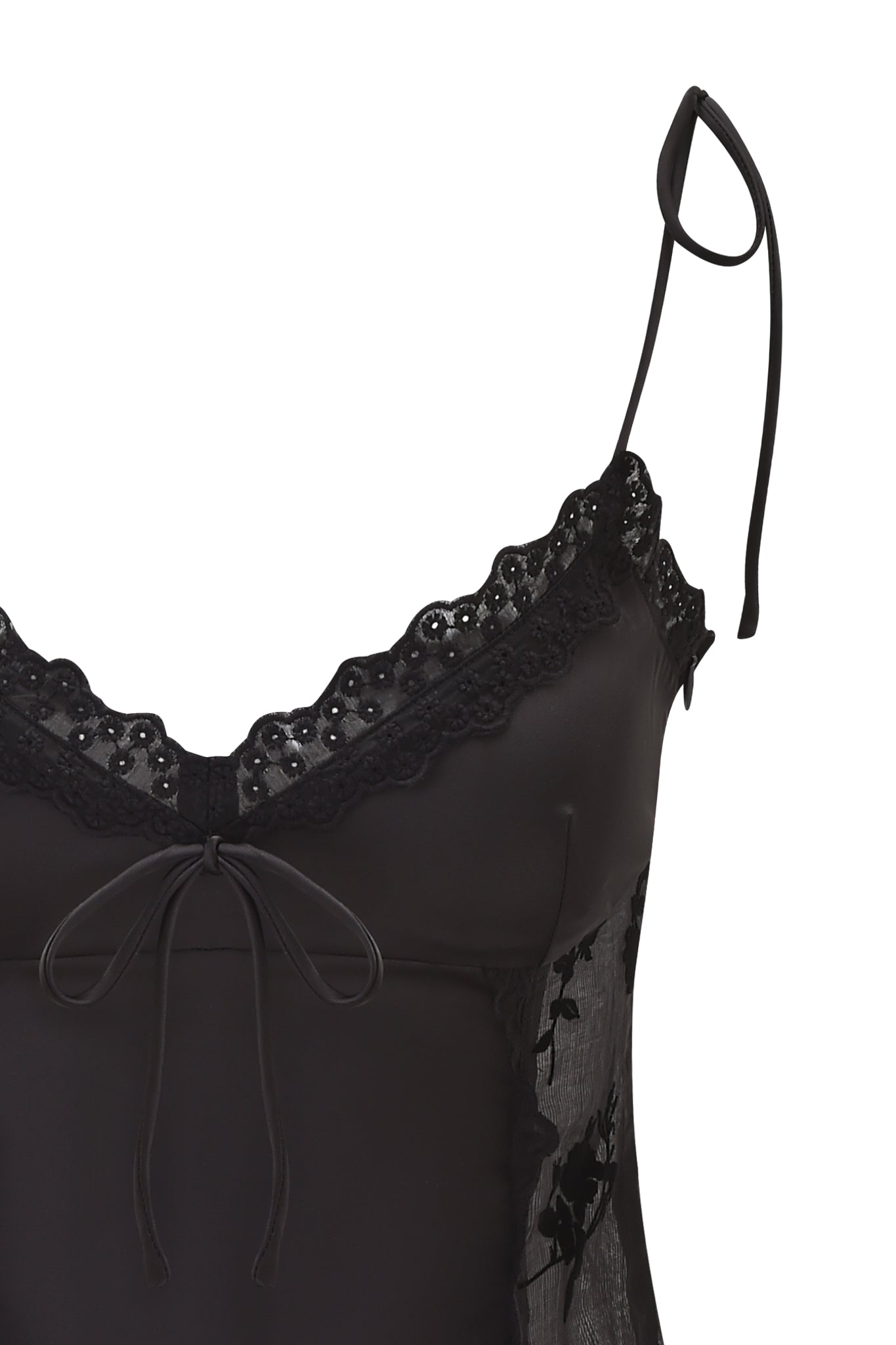 The MEADOW WOVEN CAMISOLE TOP by I.AM.GIA is a black cami featuring lace trim, a bow at the neckline, thin adjustable straps, and sheer side panels with delicate floral embroidery.
