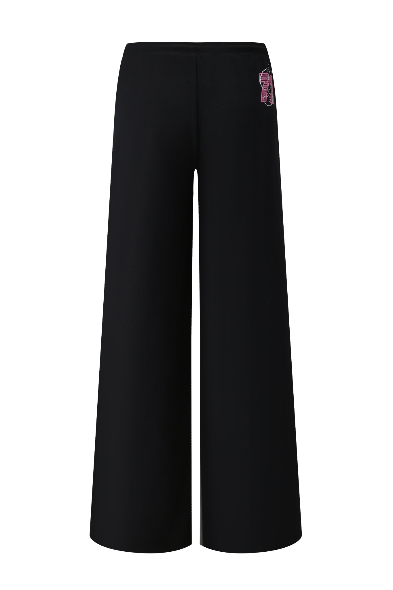 The ARLO TRACK PANT - BLACK by I.AM.GIA is a black wide-leg track pant with a high waist and a small pink and red embroidered design near the waistband, featuring a minimalist style without visible pockets or fastenings.