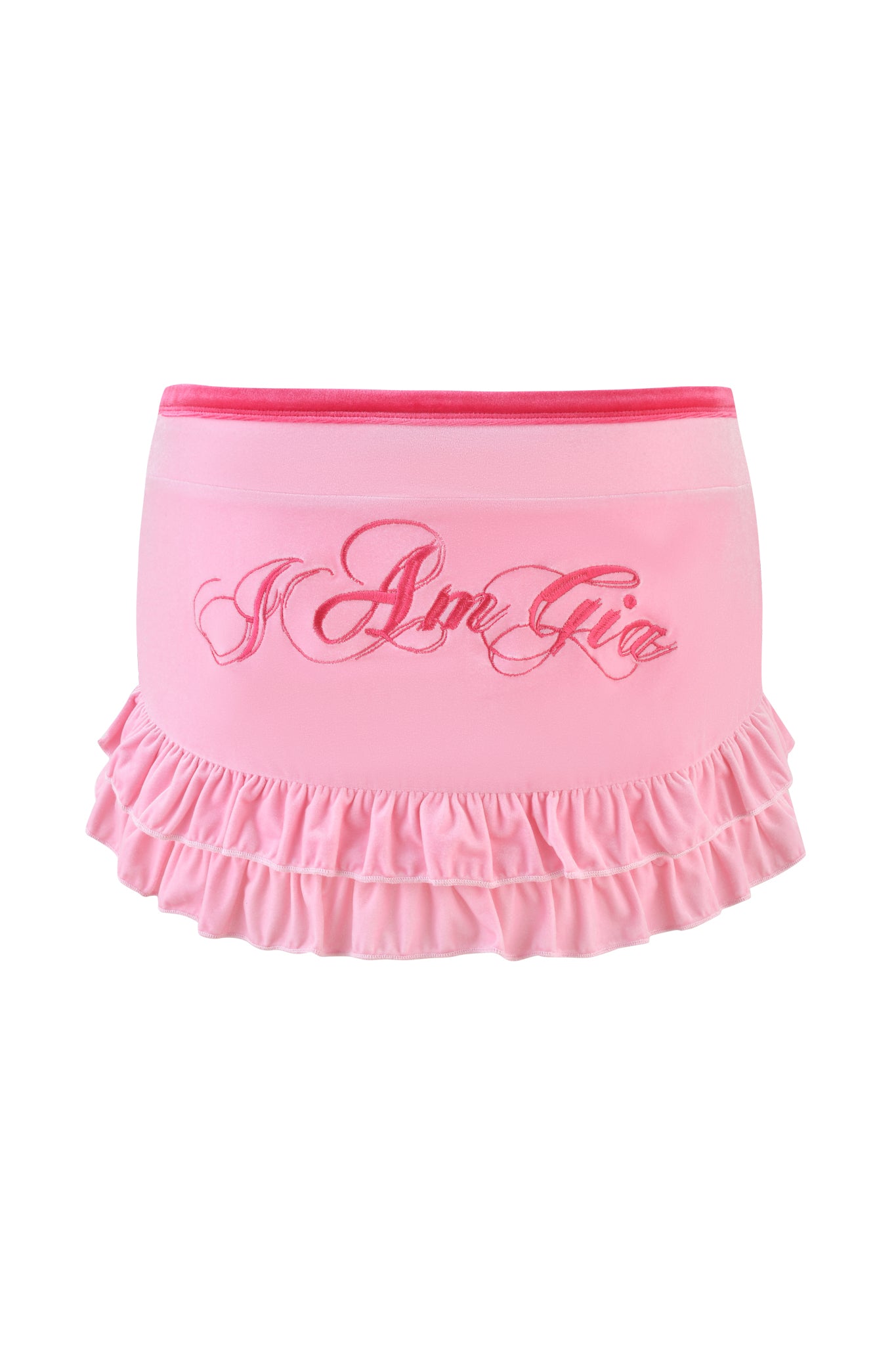 The I.AM.GIA Michelle Velour Mini Skort in pink features a velour texture, flirty ruffled hem, low-rise waist, and embroidered "I Am Gia" text on the front, blending playful charm with modern fashion.