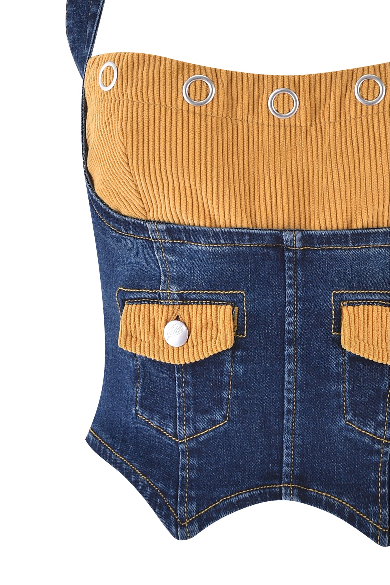Close-up of the I.AM.GIA TOMMIE CORSET - DARK WASH, a body-con denim top with mustard corduroy ribbed bust and pocket flaps, finished with silver rivets and pocket buttons.