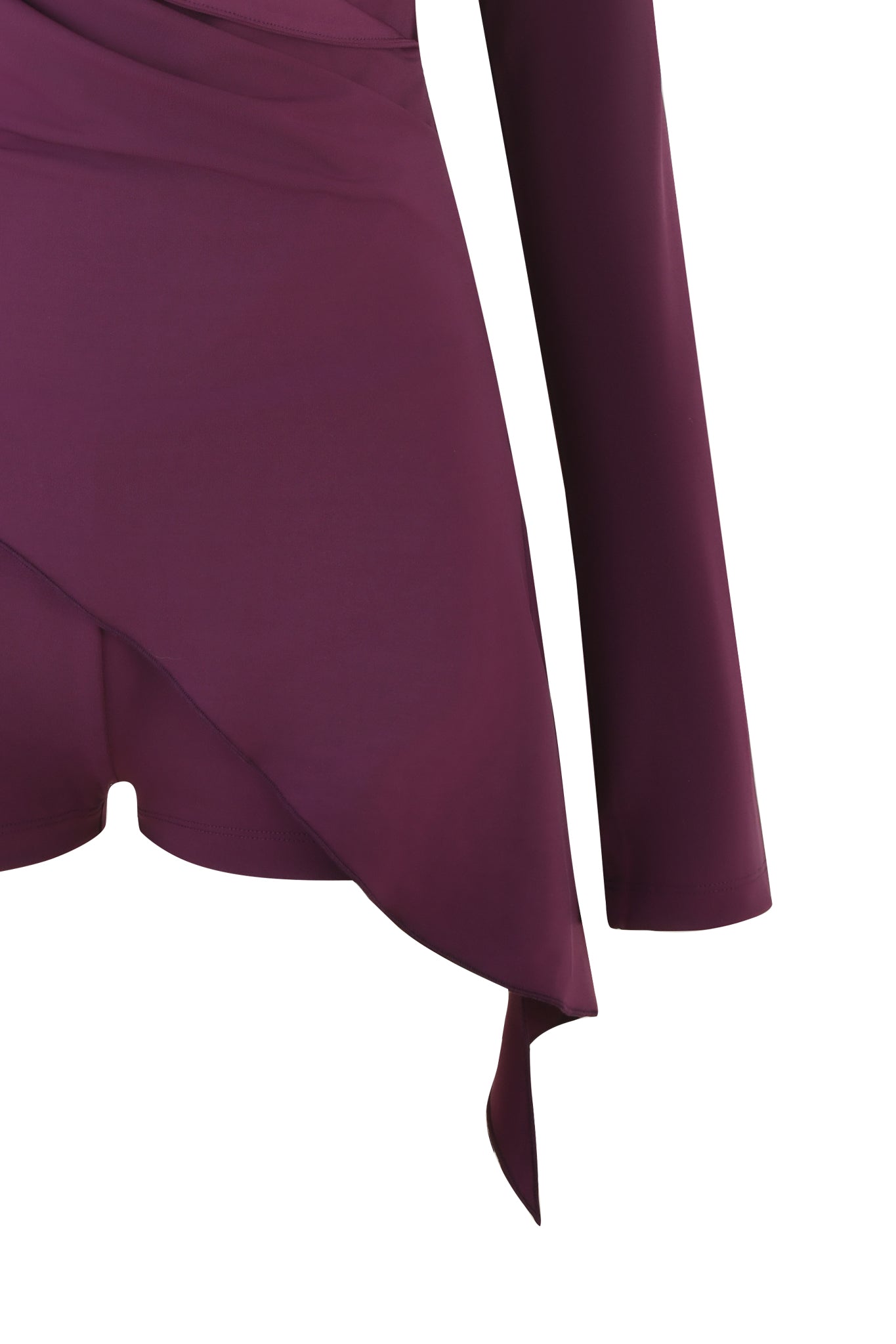 Close-up of the IRINA PLAYSUIT - PURPLE : PLUM by I.AM.GIA, showcasing a soft, flowy garment with long sleeves, an asymmetrical hemline, and draped fabric in a rich plum colorway.
