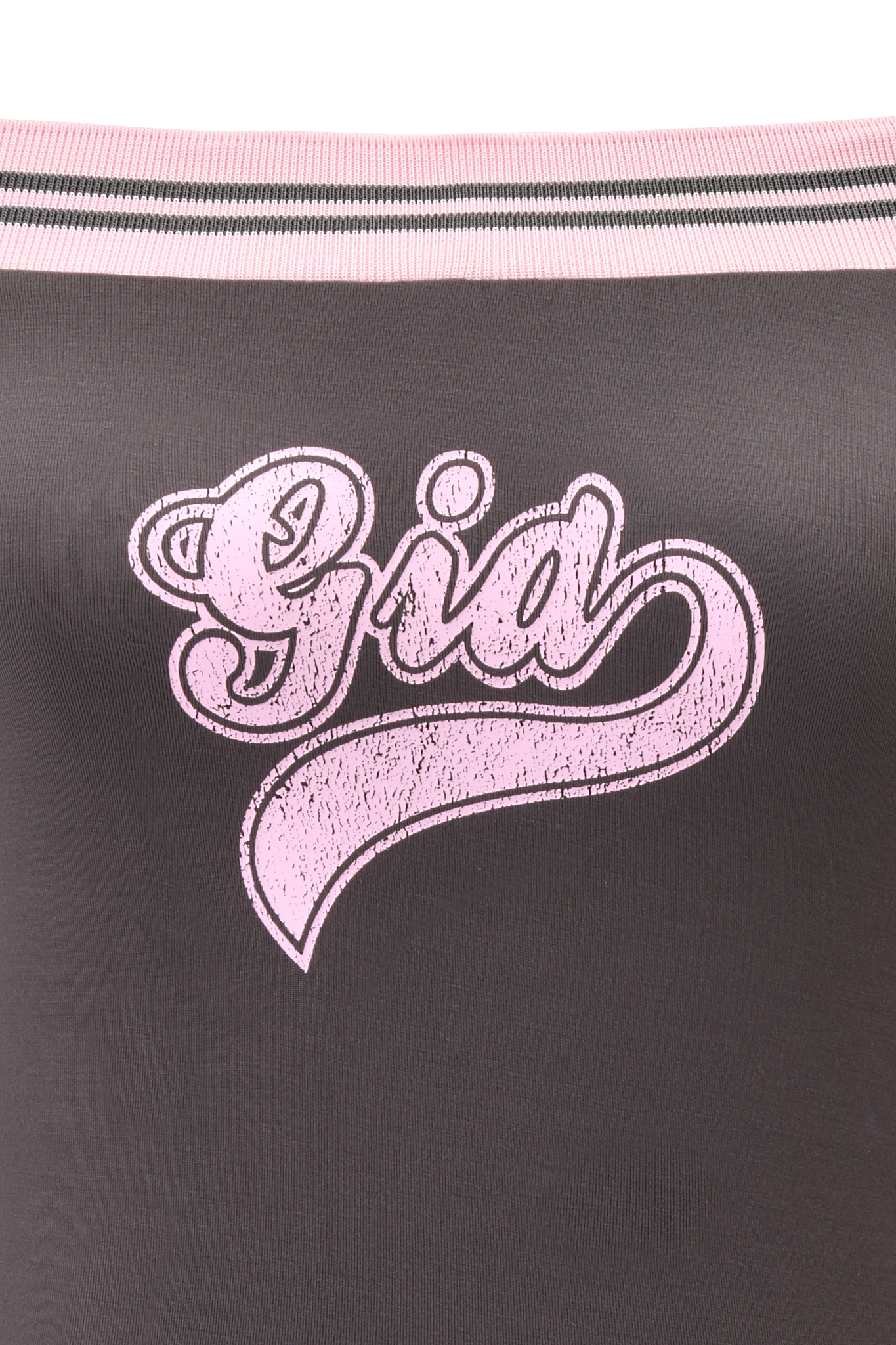 The ELLIS TOP - GREY by I.AM.GIA features charcoal grey off-shoulder fabric, "Gia" in bold pink textured script with a swoosh underline, and sporty pink and black striped trim along the top edge for a collegiate look.