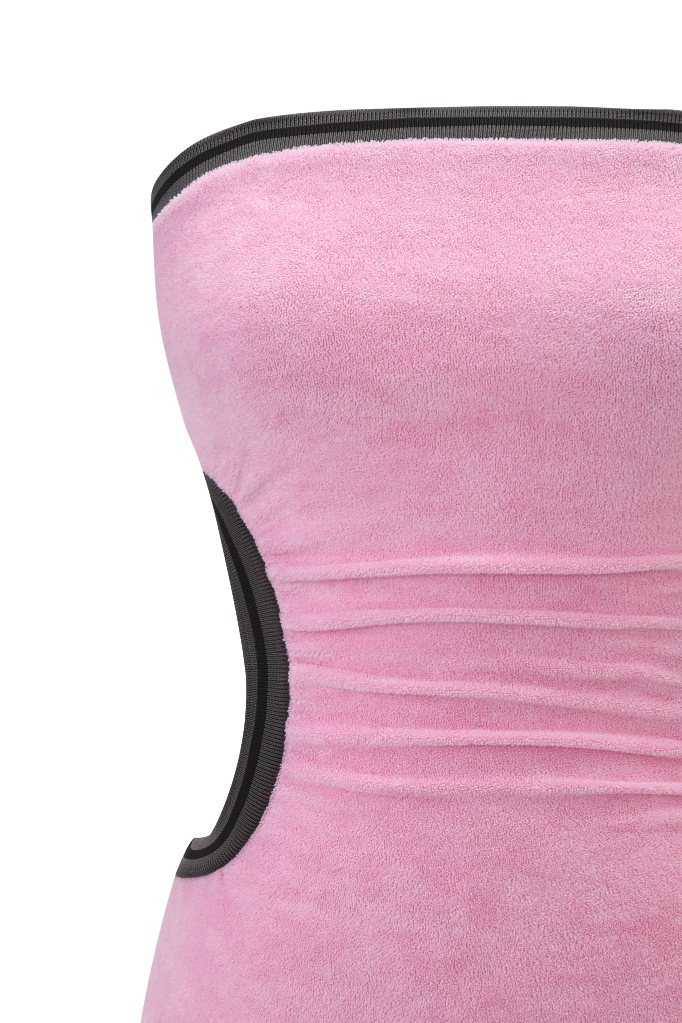 A close-up of a person wearing the I.AM.GIA DANI MINI DRESS in pink terry towelling with black trim, showing upper body and side view against a blurred background.