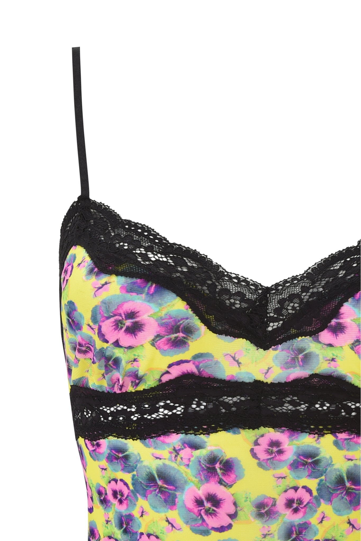 The I.AM.GIA GRACIE LACE CAMI - SASSY PANSY features a neon purple and blue floral print on bright yellow mesh, thin straps, and black lace trim along the neckline.