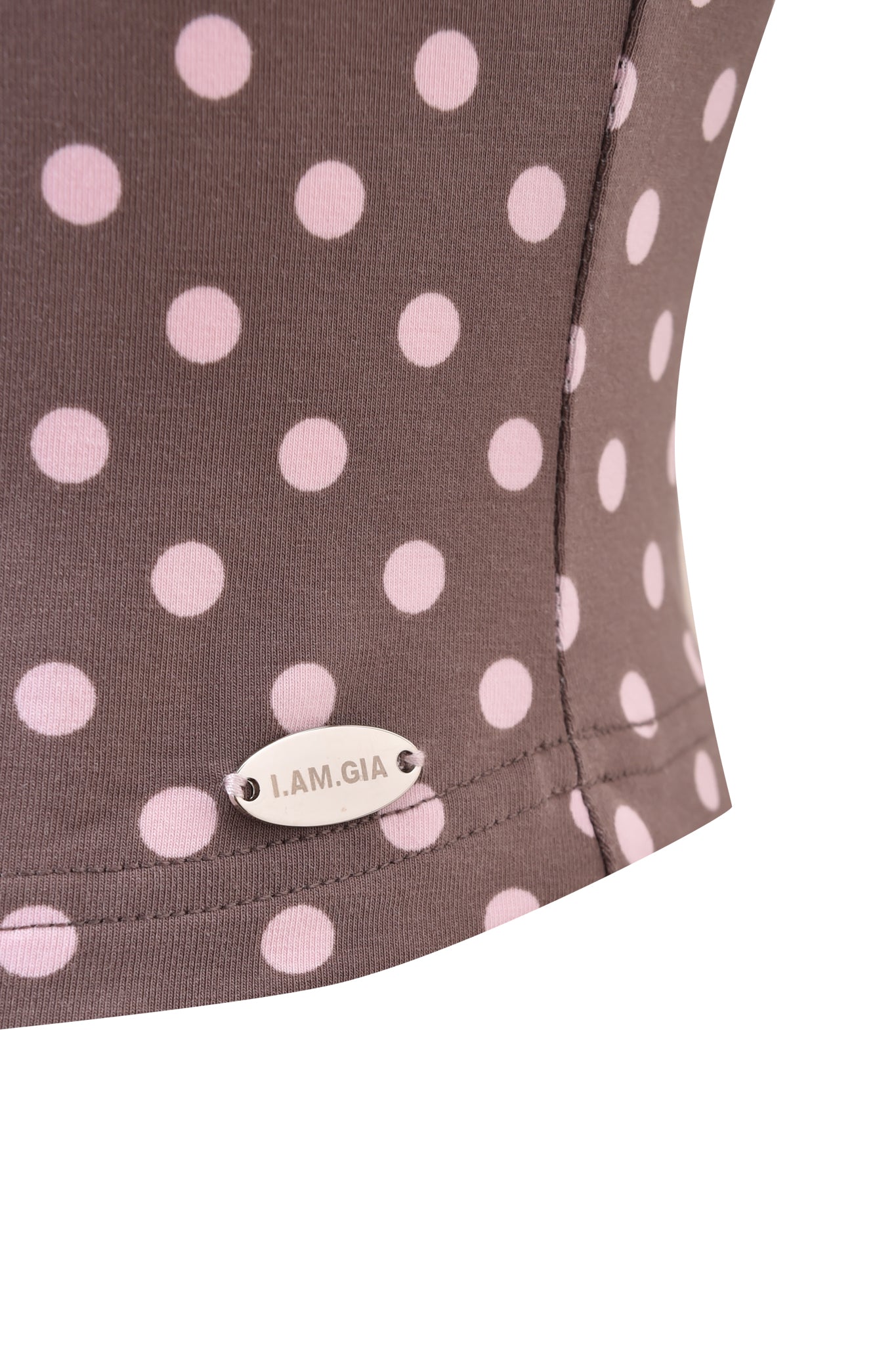 Close-up of the I.AM.GIA BLARE HALTER STRAP TOP - PINK CHOCOLATE, featuring a pink polka dot print on brown fabric and a small silver “I.AM.GIA” tag near the seam.