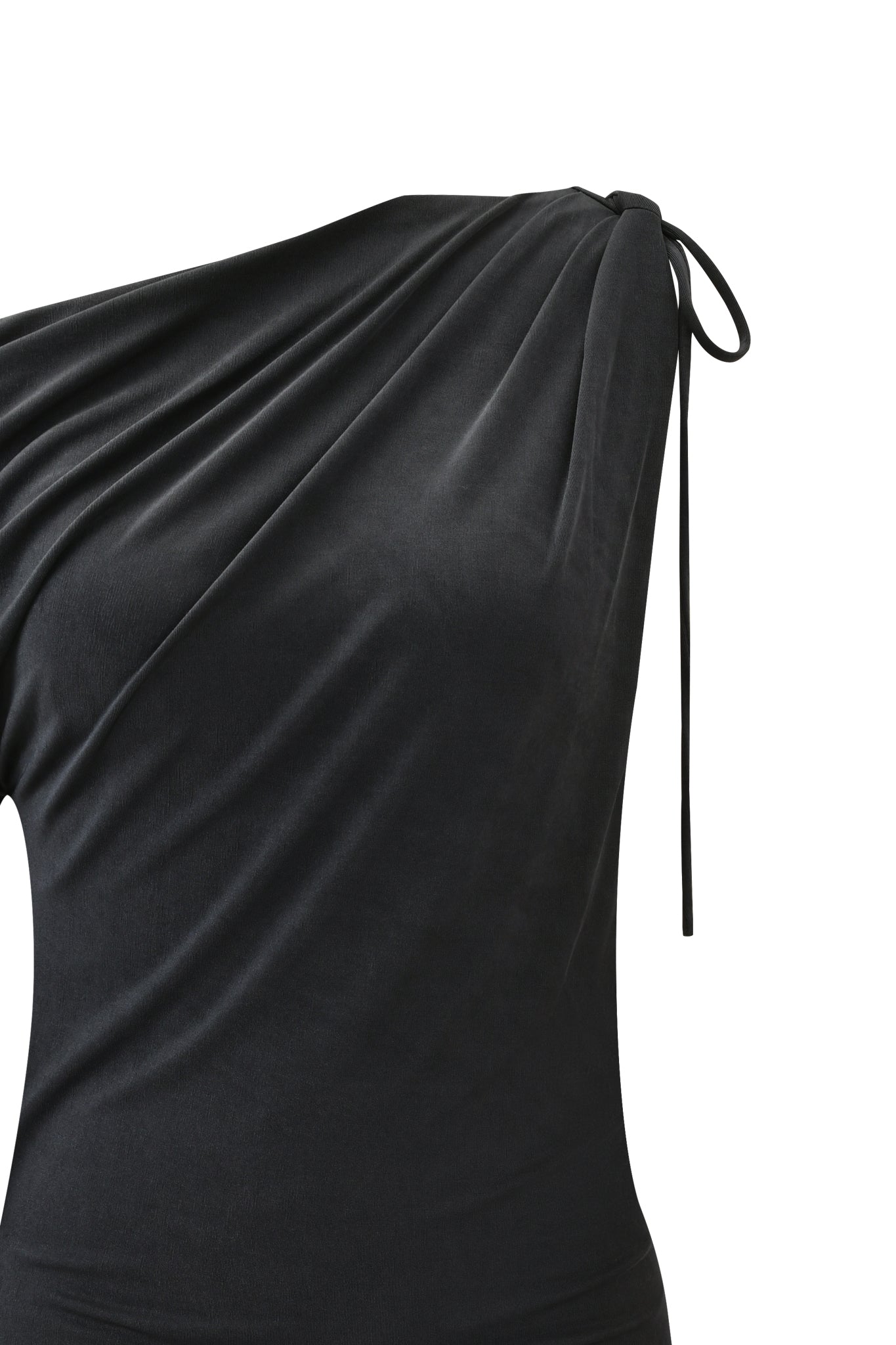 Close-up of the I.AM.GIA JOLIE MINI DRESS in Steel—a black asymmetrical mini dress with gathered fabric and a thin tie at one shoulder, shown against a plain white background.