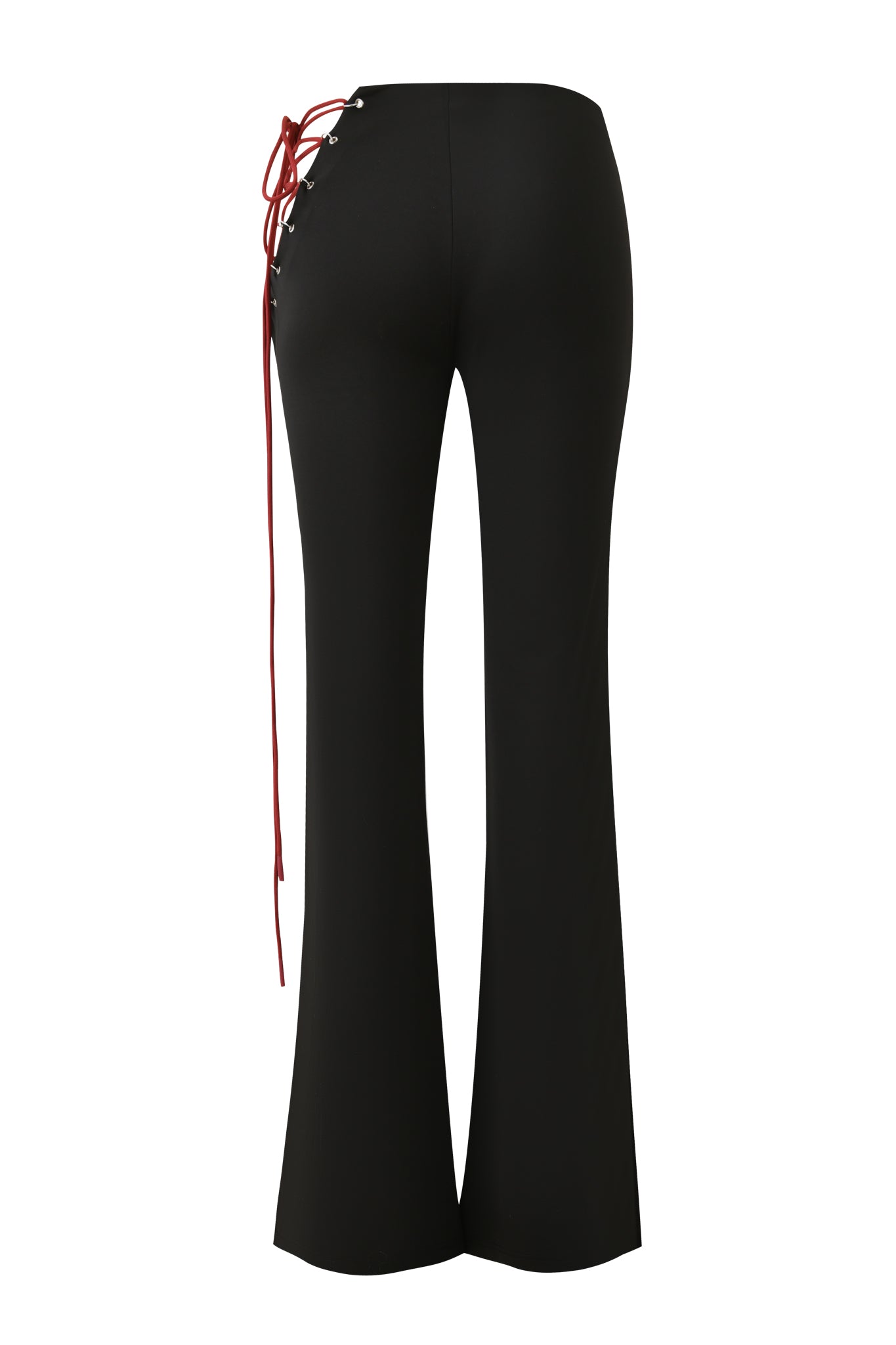 The ONYX PANT - BLACK by I.AM.GIA features a high waist, black sueded jersey fabric, and a striking red lace-up detail on the left side tied in a bow with long ends, shown from the back in a flared silhouette.
