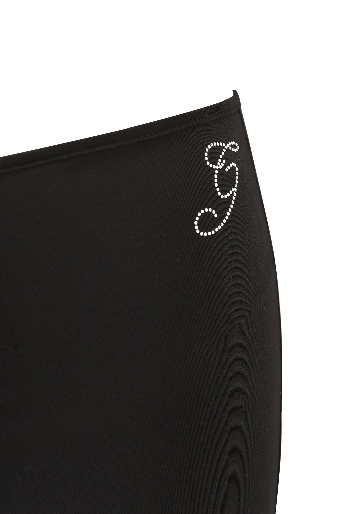 Close-up of the I.AM.GIA HALO PANT - SOLID BLACK featuring a decorative letter "G" in small rhinestones near the waistband.