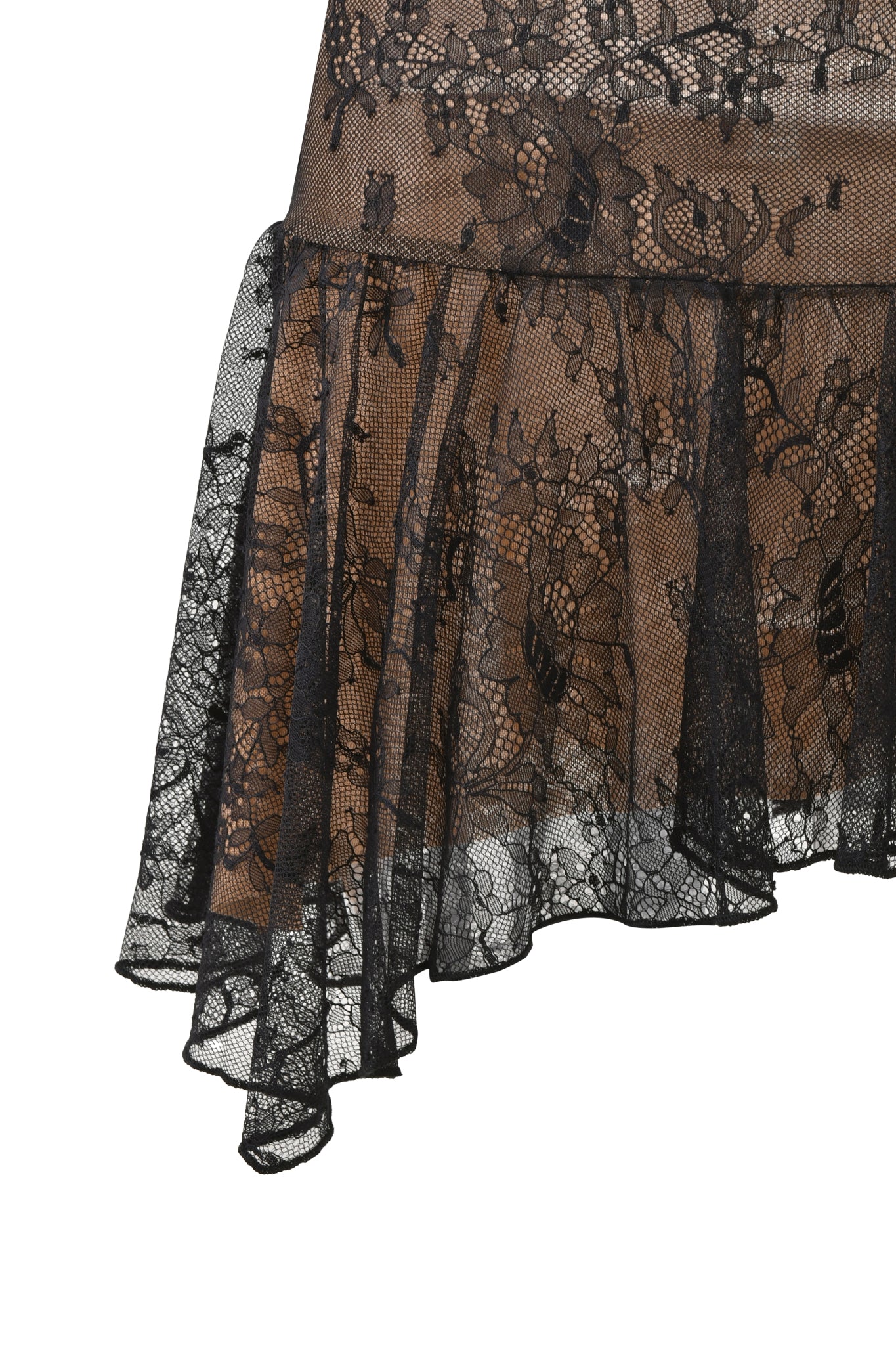 A close-up of the I.AM.GIA STEVIE SKIRT in black, showcasing sheer floral lace with an asymmetrical ruffled hem over a beige backdrop.