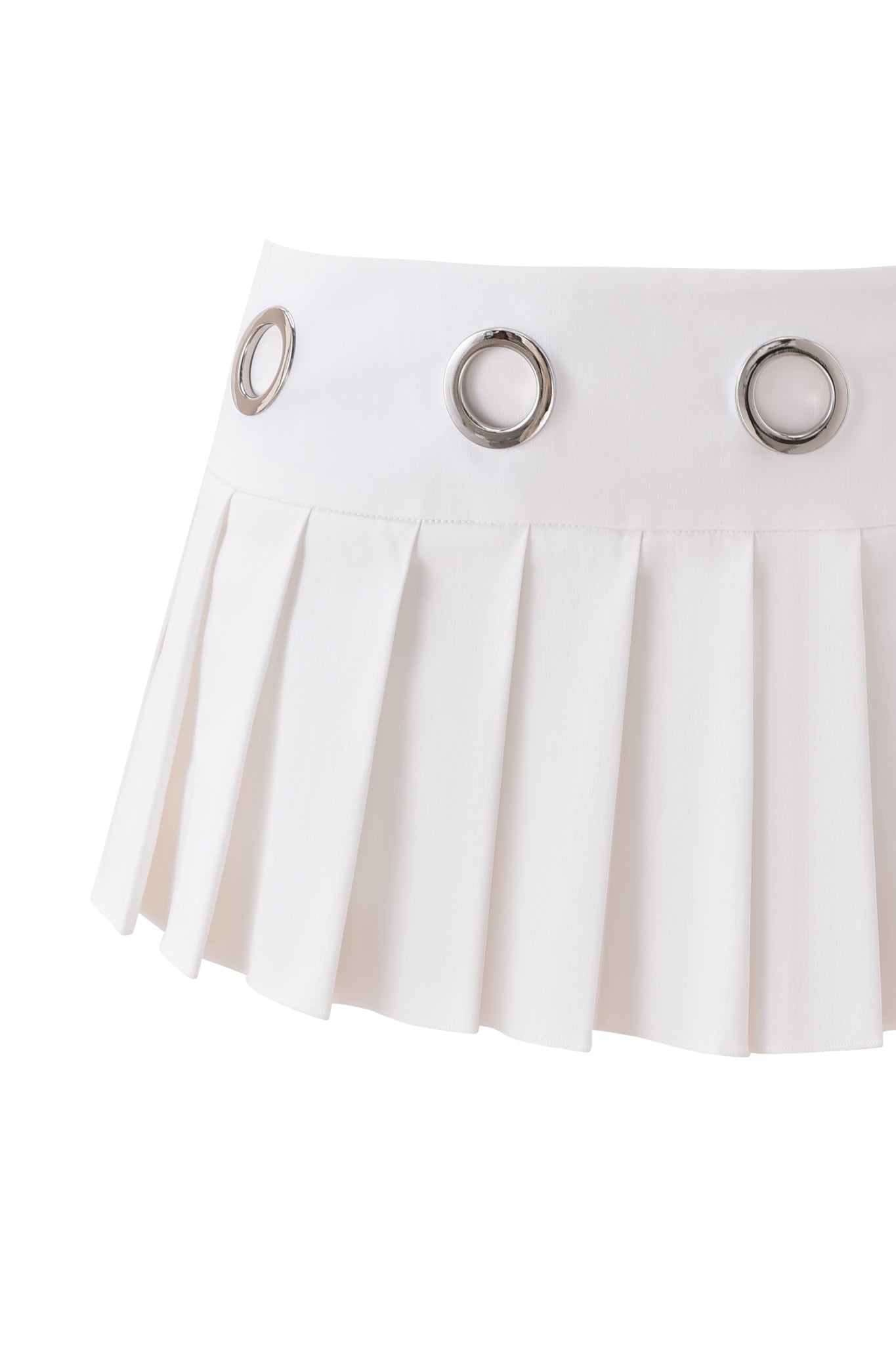 The JAYMES SKORT - WHITE by I.AM.GIA is a white mini skort featuring a low-rise waist, crisp pleats, and three large silver grommets on the waistband, shown against a plain white background.