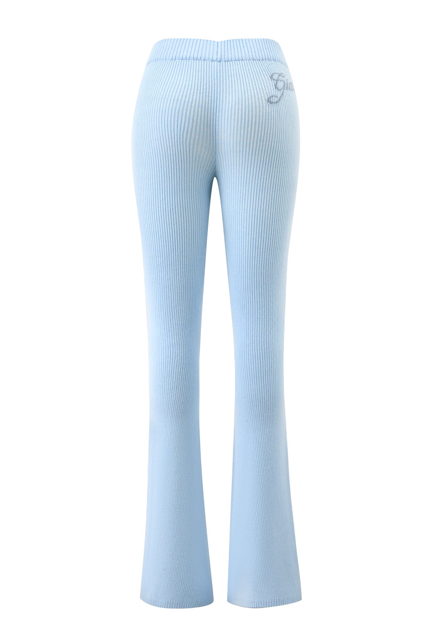 The I.AM.GIA BLARE KNIT TRACKPANT - BLUE features a light blue knit, mid-rise elasticated waistband, flare leg opening, and embroidered logo on the upper left. Shown from the back against a white background.