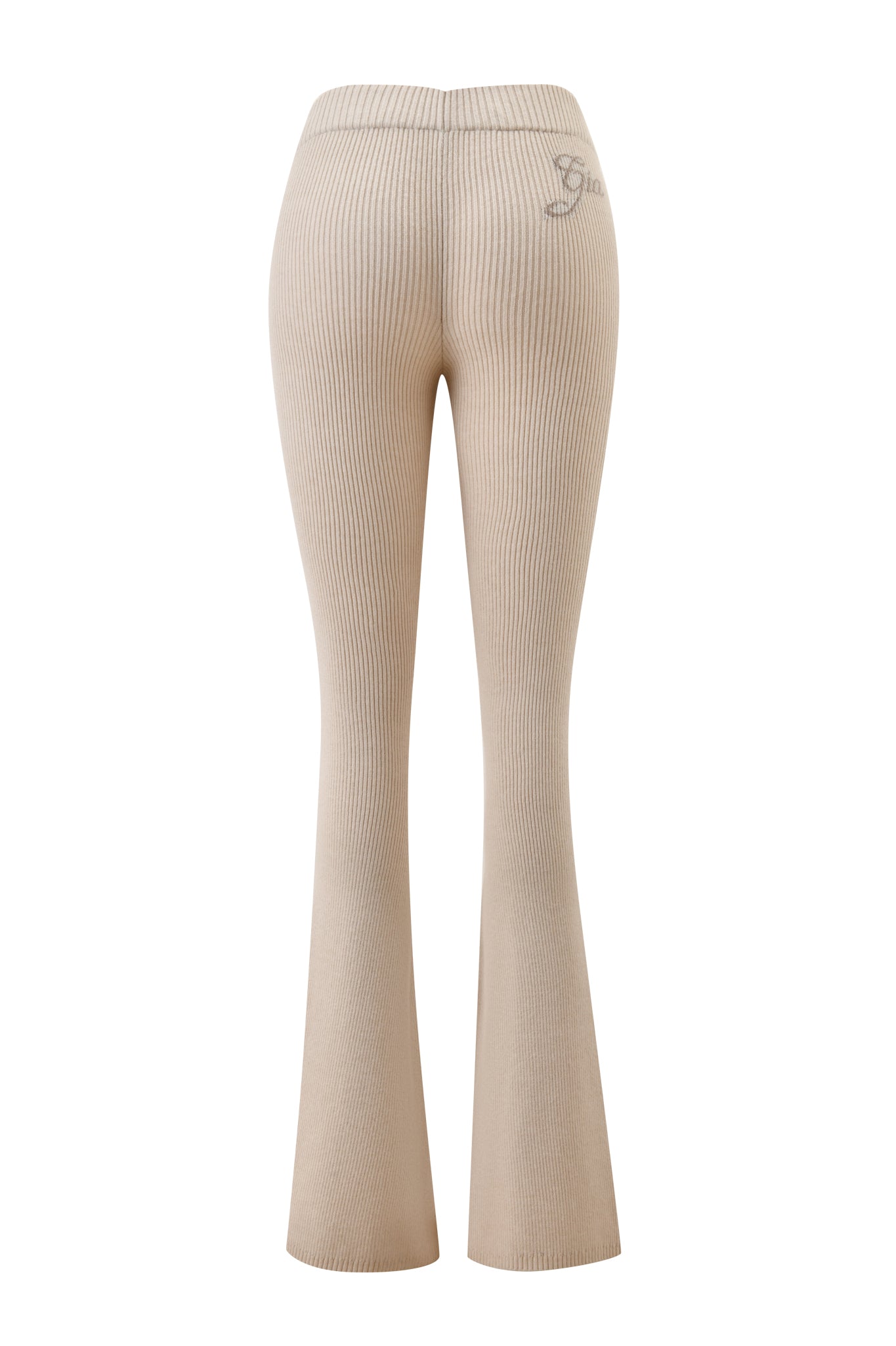 The BLARE KNIT TRACKPANT - CREAM by I.AM.GIA is a beige, ribbed trackpant with a mid-rise elastic waistband, flared leg opening, and subtle embroidered logo near the right waistband. Shown from the back.