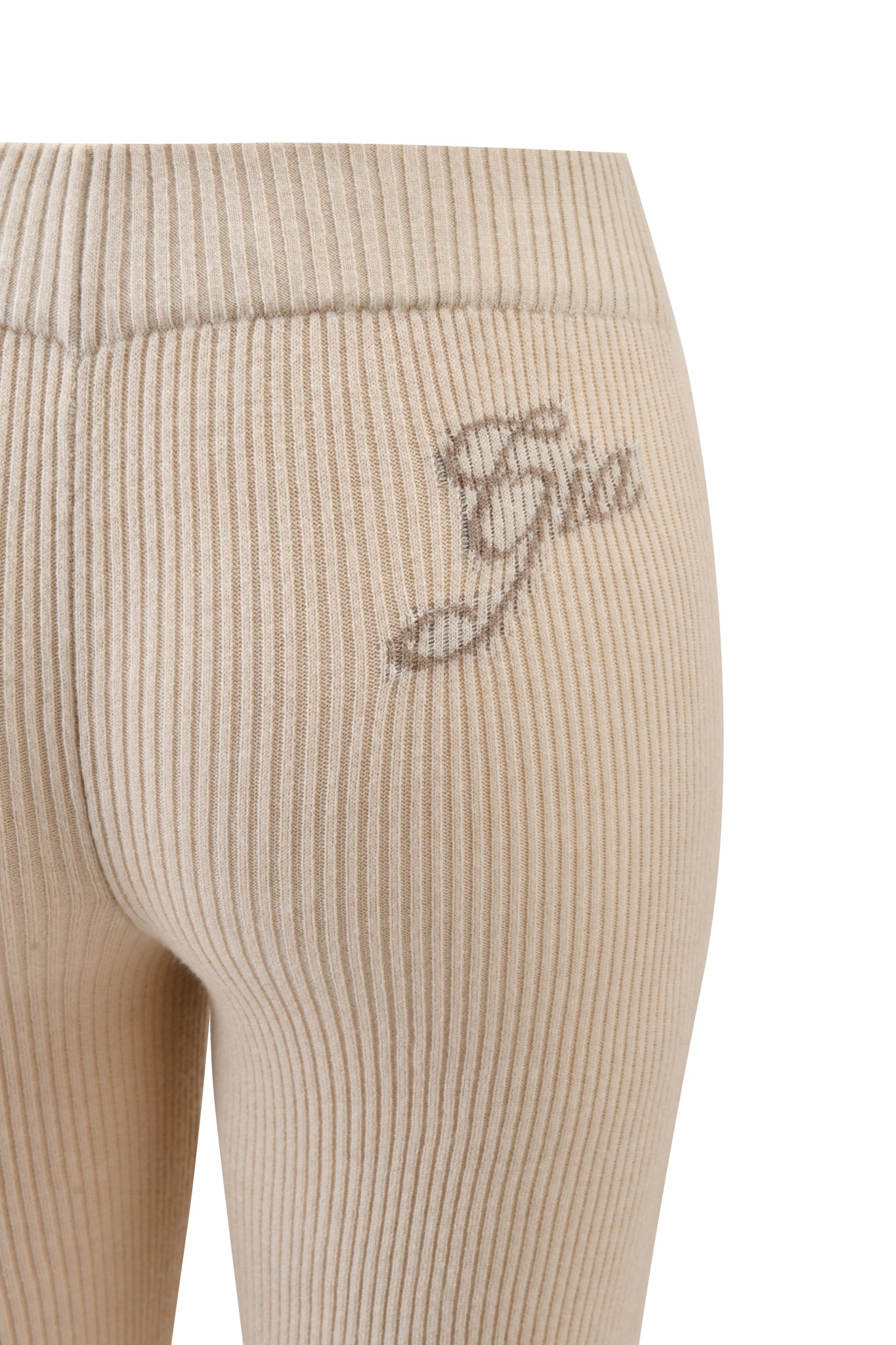 Close-up of I.AM.GIA BLARE KNIT TRACKPANT in cream, featuring a mid rise elastic waistband, "Gia" cursive embroidery near the top, ribbed form-fitting design, and subtle flared legs against a white background.