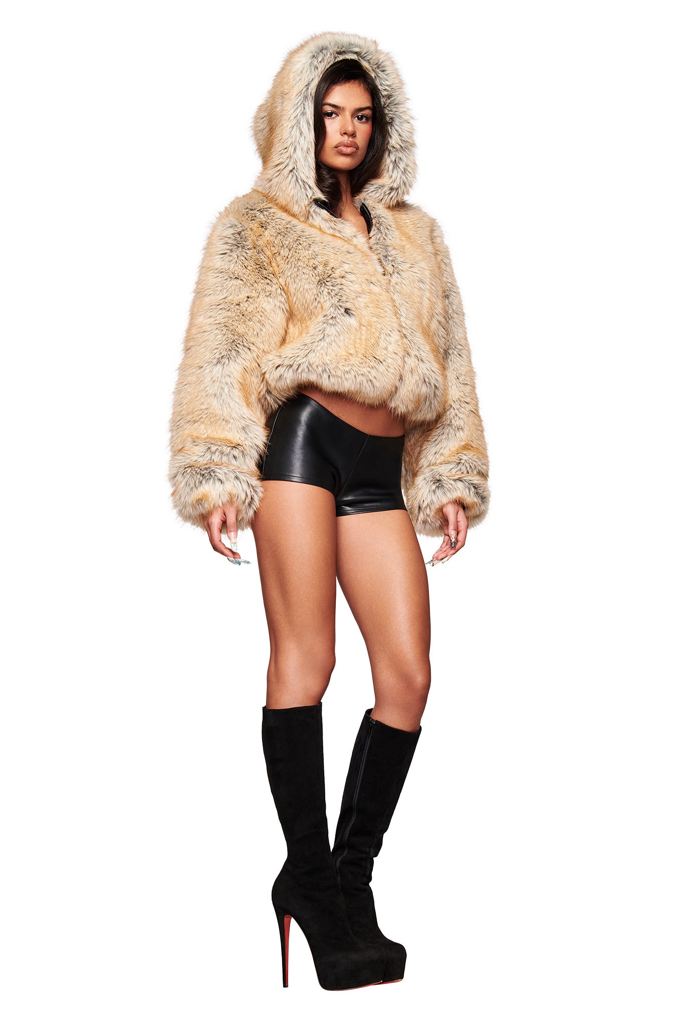 A person wearing the I.AM.GIA EVEREST REVERSIBLE JACKET in brown, black high-waisted shorts, and knee-high black platform boots stands confidently against a white background.