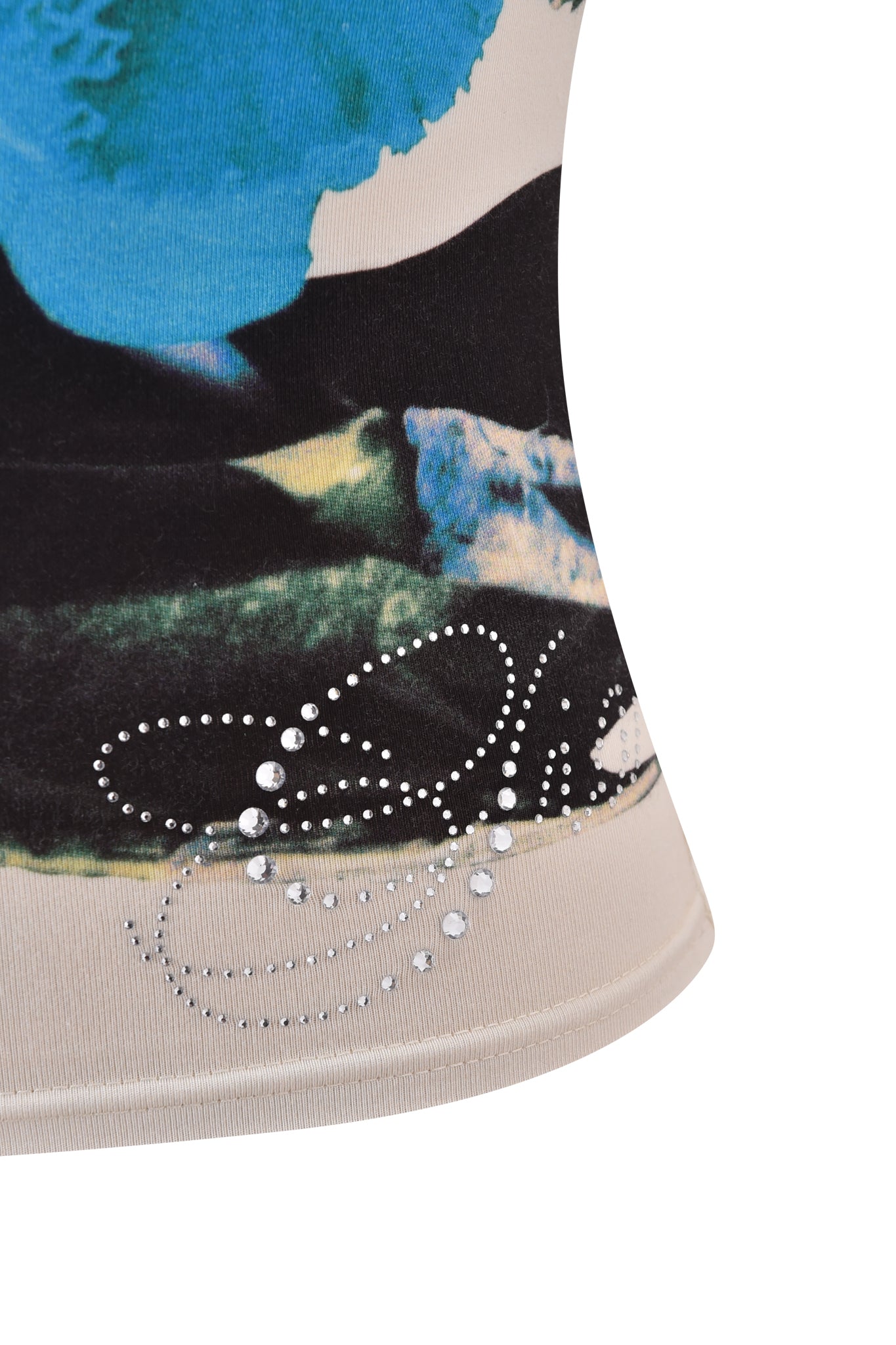 Close-up of the ADELLA TOP - BLUE by I.AM.GIA, featuring an abstract blue, black, and green pattern with small rhinestones in a curved dotted design near the hem for a distinctive touch.