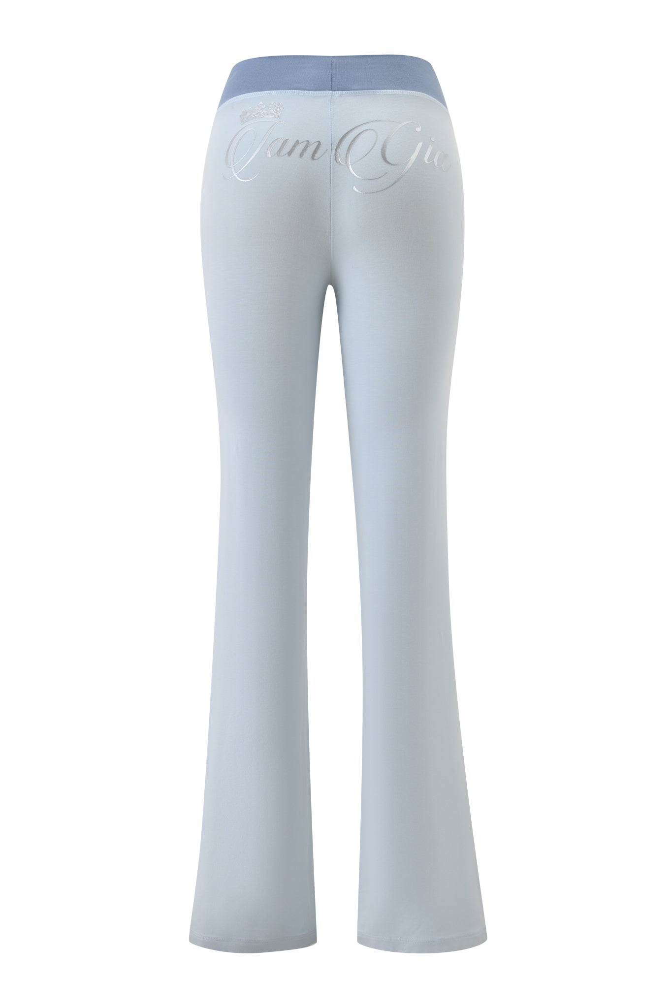 Two-tone powder blue BLARE LOWER RISE TRACKPANT by I.AM.GIA shown from the back, featuring a wide waistband and silver cursive "I am Gia" text across the upper back.